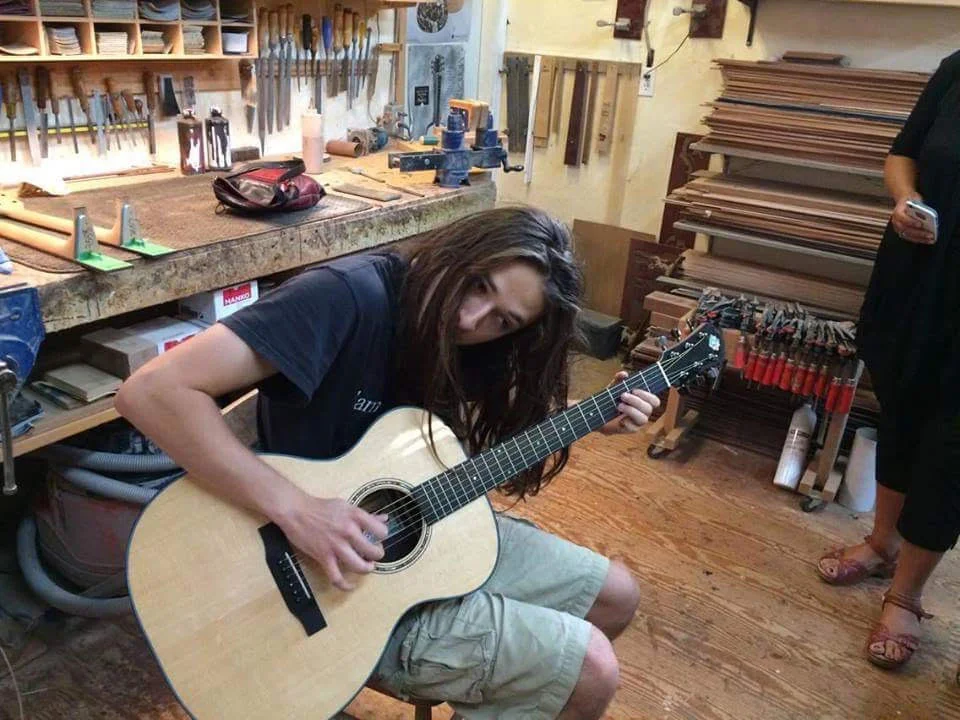 Farley trying out his new guitar in David's workshop. 