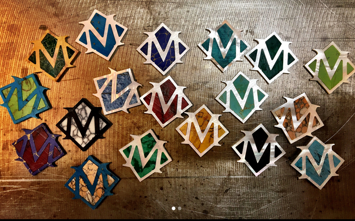 All the interior pieces this time are made from various types of stone such as obsidian, lapis, jasper, turquoise. The coloured M's are also made from different stones. Some of them will make it onto a peghead. Some won't. 
