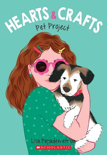 Hearts and Crafts book Two features a middle school girl holding a gray dog