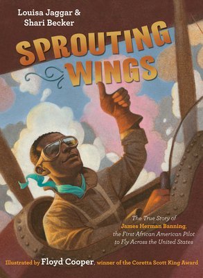 J. H. Banning gives a thumbs up as he makes his historic flight. This is what's pictured on the cover of with biography titled Sprouting Wings