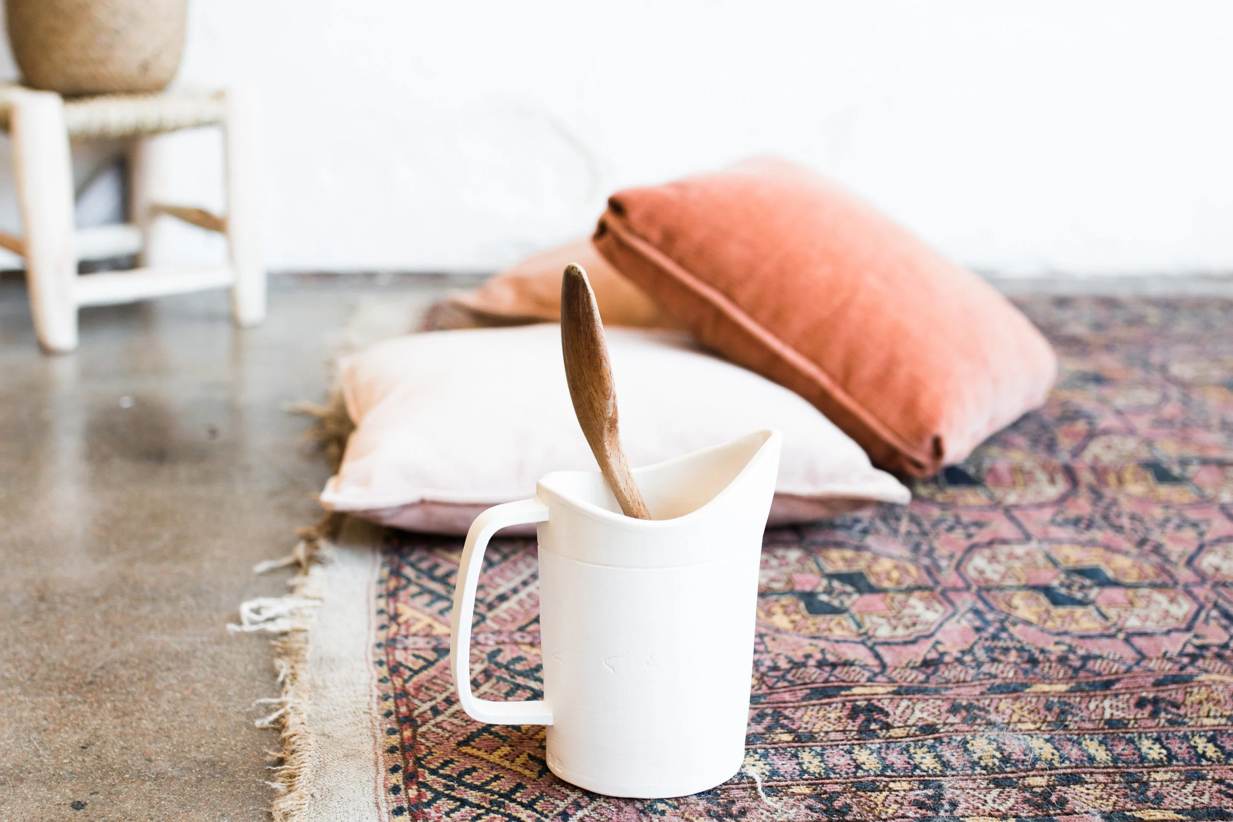 Here is a simple example. This image has a SHALLOW depth of field and a WIDE aperture. The pitcher and spoon are in focus, the surrounding elements are out of focus. This image was shot at f/2.8. (Image taken by Tina Lynn Photography from Kindred Photography Workshop - Tulsa)