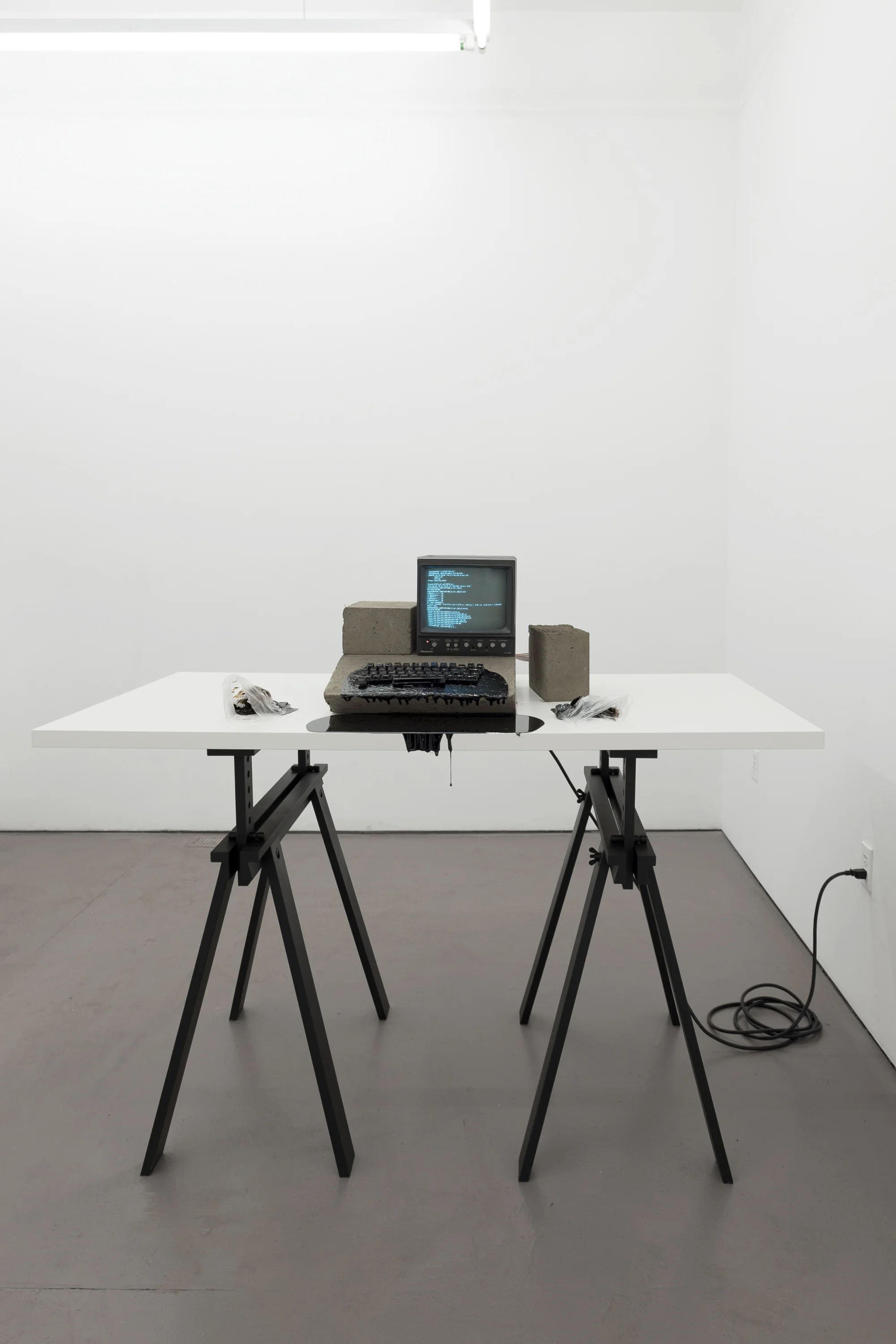 Mother of All Demos, 2018 Dirt, 9” monochrome CRT monitor, computer parts, Linux operating system, subwoofer cable, wood, asphalt, plastic gloves (photo courtesy HOUSING, Brooklyn, NY)