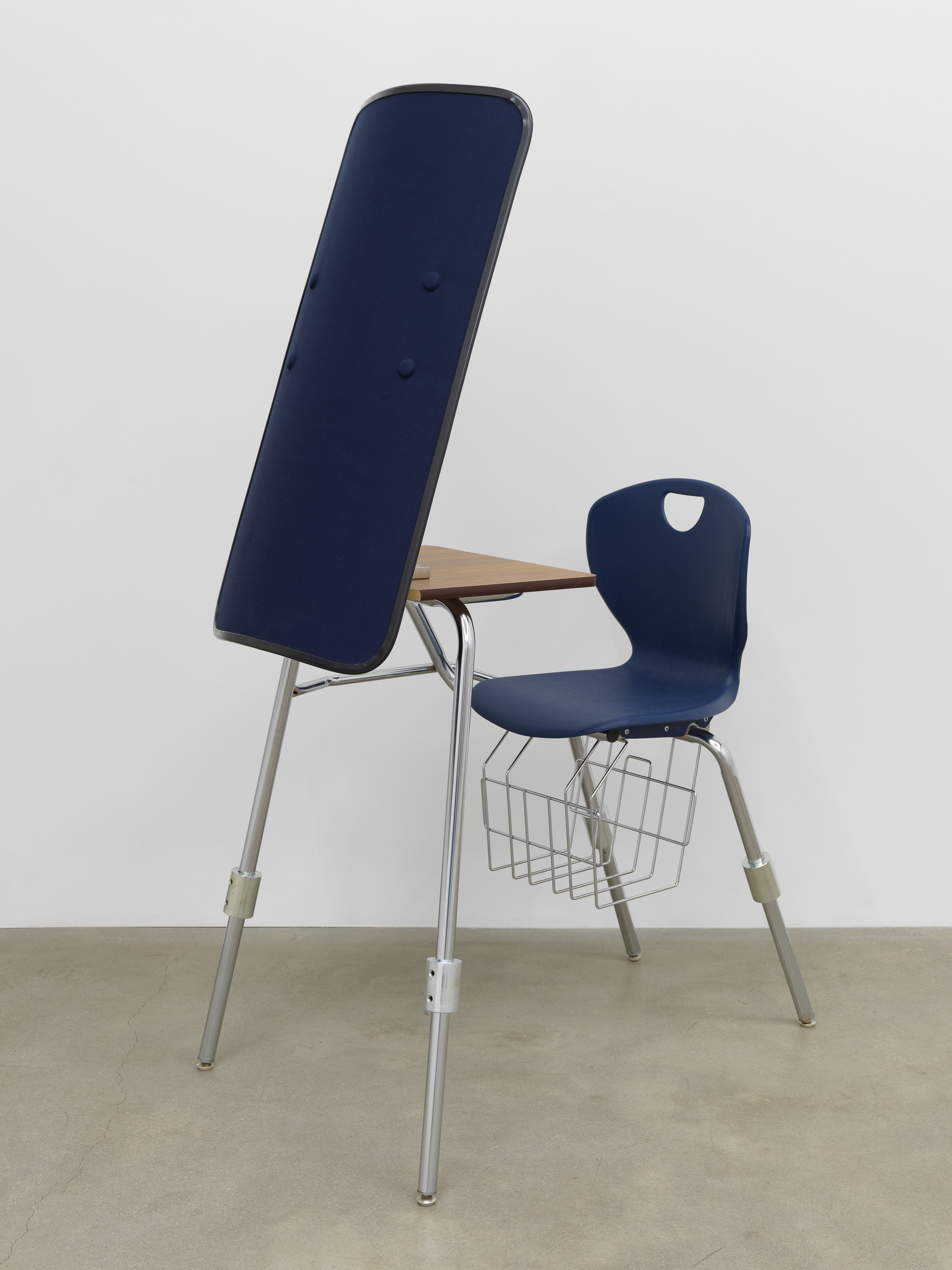 American Artist I'm Blue, 1 , 2019, school desk, hardware, ballistic shield, navy blue fabric, books, 66 x 24 x 35 in (167.6 x 61 x 88.9 cm)