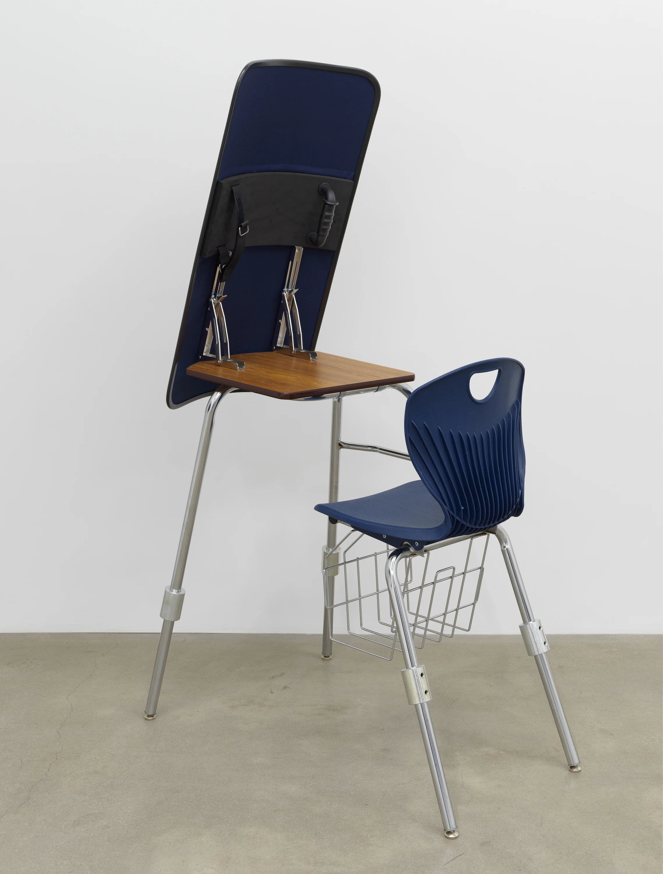 American Artist I'm Blue, 1 , 2019, school desk, hardware, ballistic shield, navy blue fabric, books, 66 x 24 x 35 in (167.6 x 61 x 88.9 cm)
