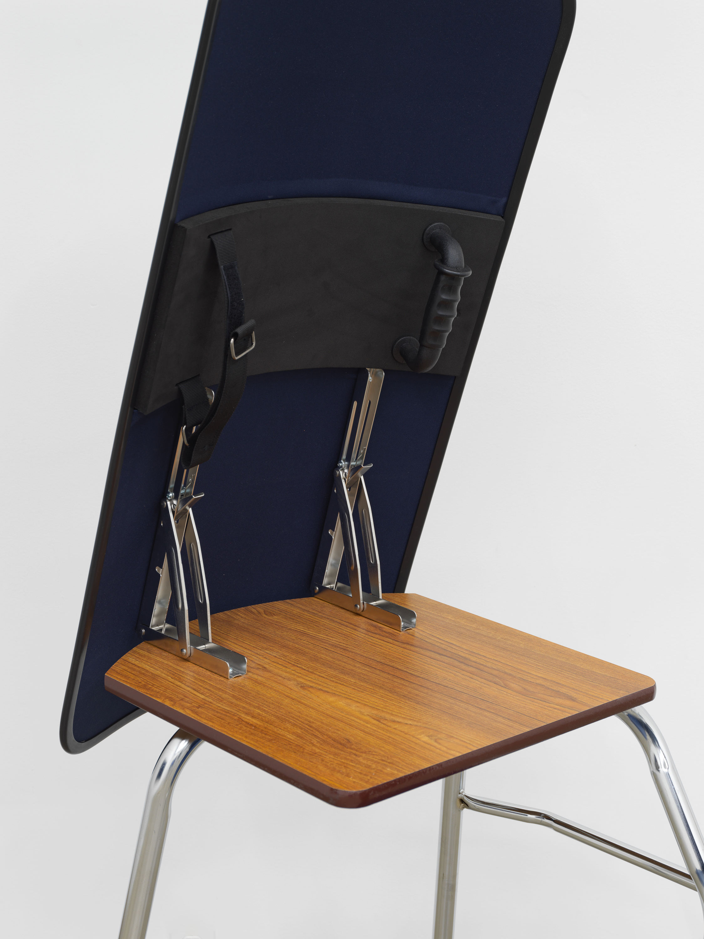 American Artist I'm Blue, 1 (Detail) , 2019, school desk, hardware, ballistic shield, navy blue fabric, books, 66 x 24 x 35 in (167.6 x 61 x 88.9 cm)