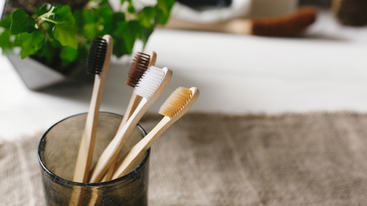 Eco+natural+bamboo+toothbrushes+in+glass+on+rustic+background+with+greenery.+sustainable+lifestyle+concept.+zero+waste+home.+bathroom+essentials%2C+plastic+free+items.jpg