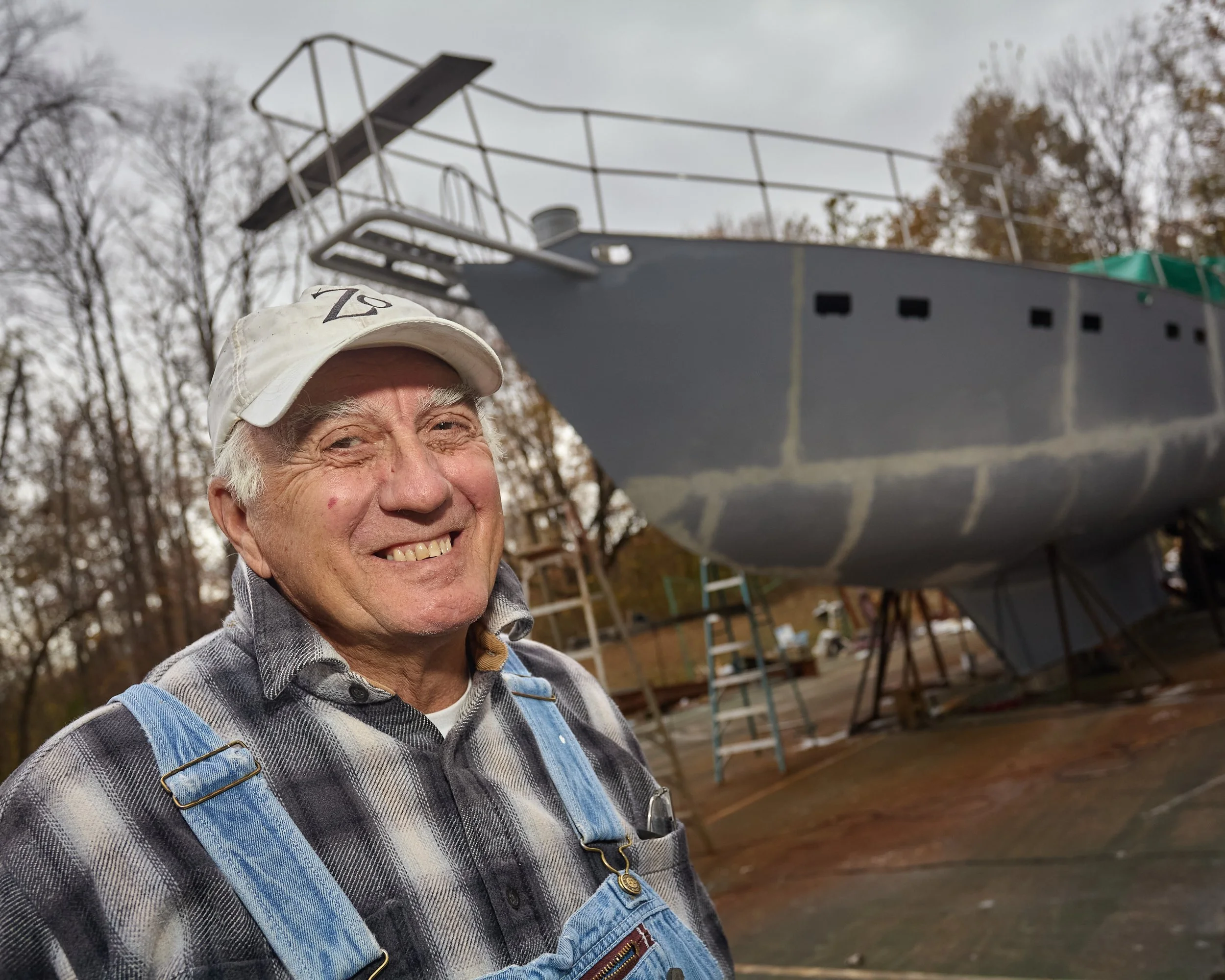 While driving across the back roads of Indiana in the fall of 2010, my friend Brent and I spotted the strangest thing... A 56' sailboat in the construction phase, on a tennis court, in rural Indiana.

We stopped and introduced ourselves to Tom West a