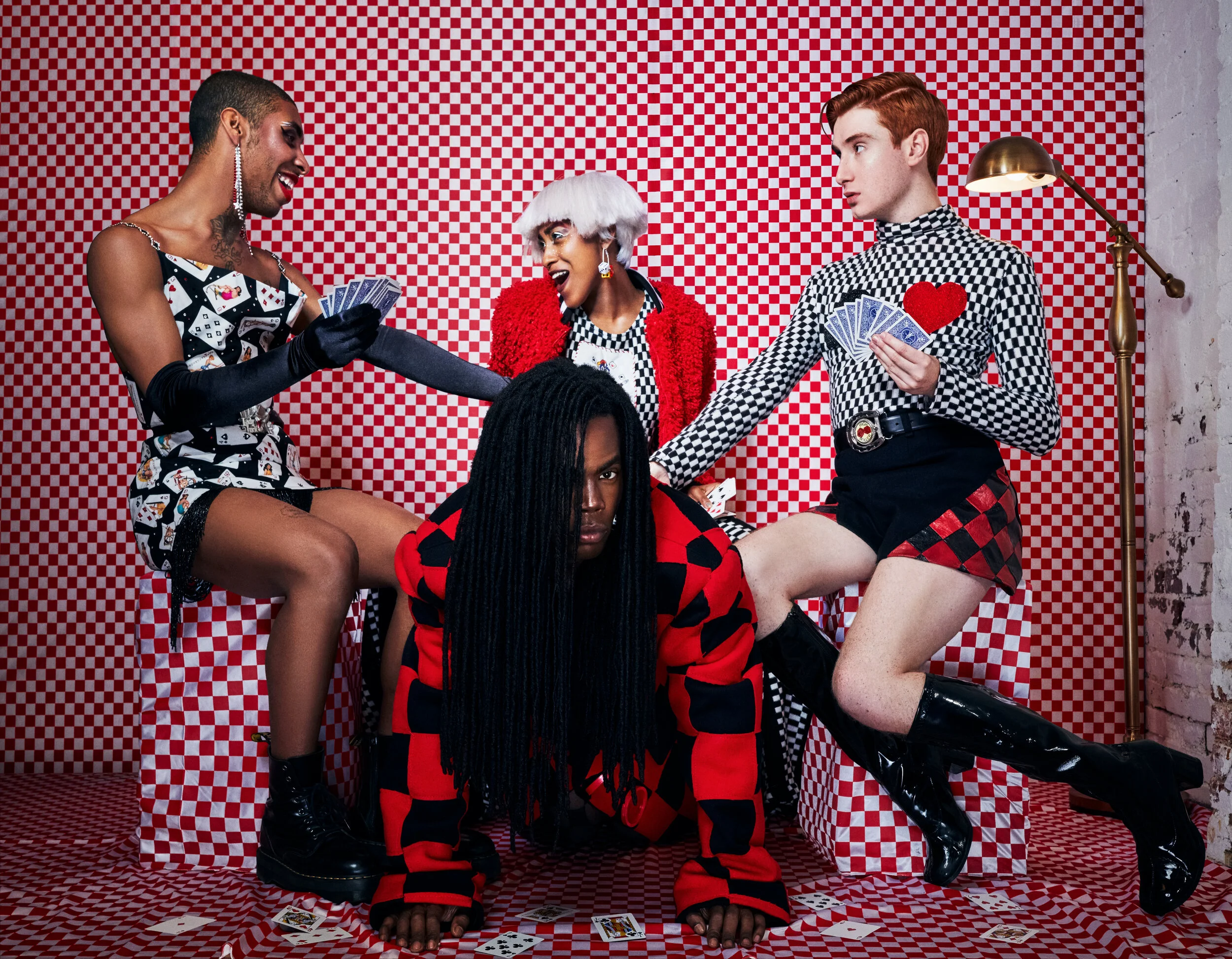 Eric: Patchwork Checker Wool Coat Dash: Checker knit turtleneck with beaded playing card patches, black wool shorts with checker leather inserts Jewell: Checker and black striped knit pants, joker tank, and red furry bomber Tommy: Vintage pinup p
