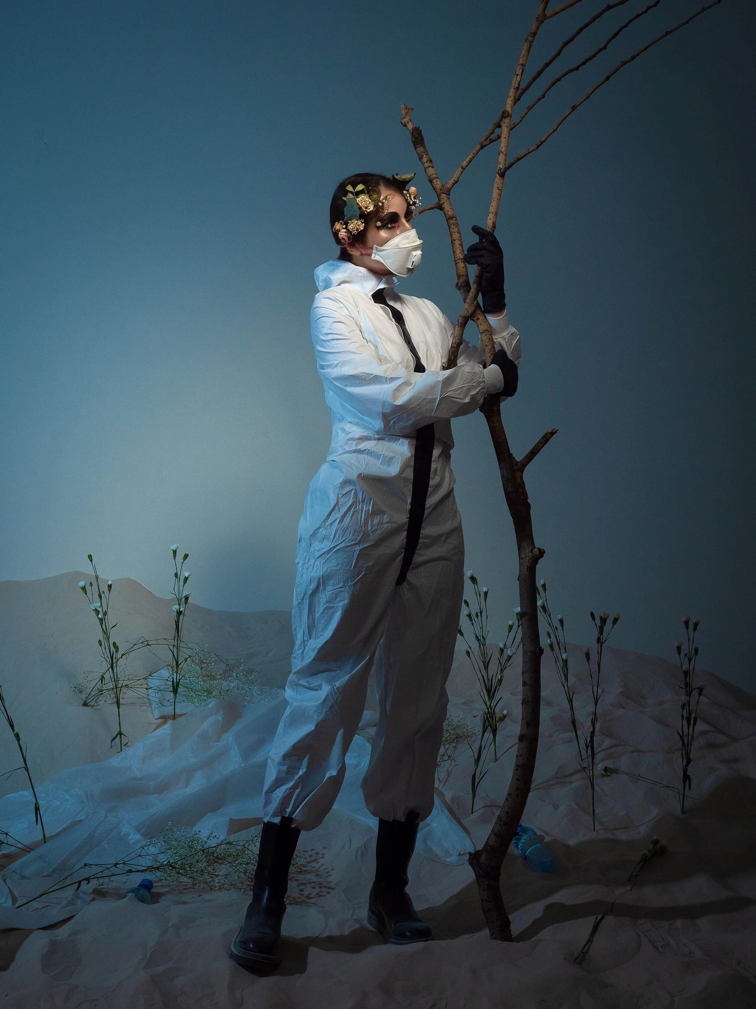 The desert, a man in a protective suit, flowers on a lifeless background as a reminder of the beauty of nature. (Copy)