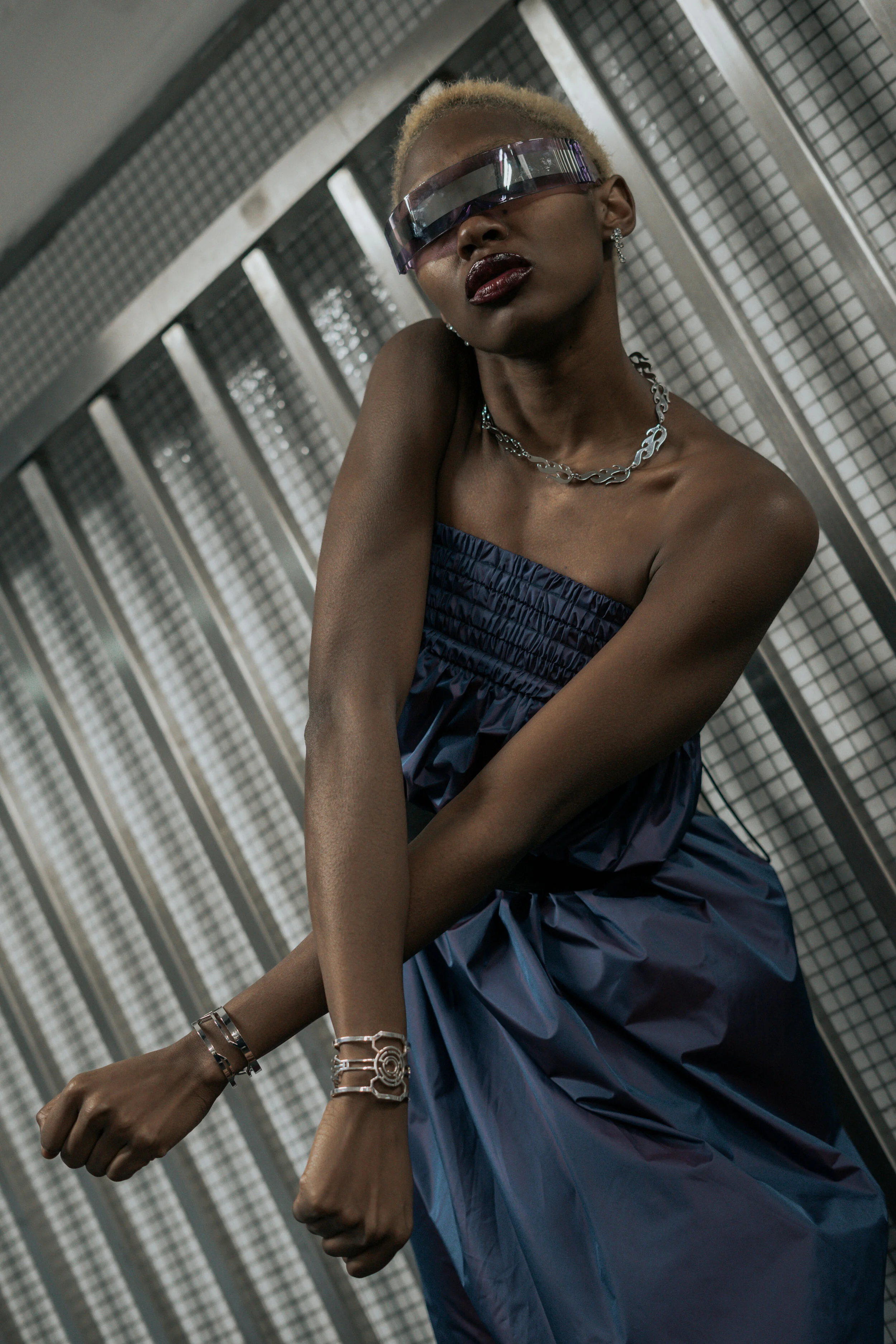 Photographer: Gaelle Andriantsarafara Female Model: Kiara Simmons Fashion Designer: Marine Arnoul Wardrobe Stylist: Stefnie K Photography Assistant: Lucie Monroe Wardrobe Credits: reflective purple light dress,sunglasses, bracelets and neck