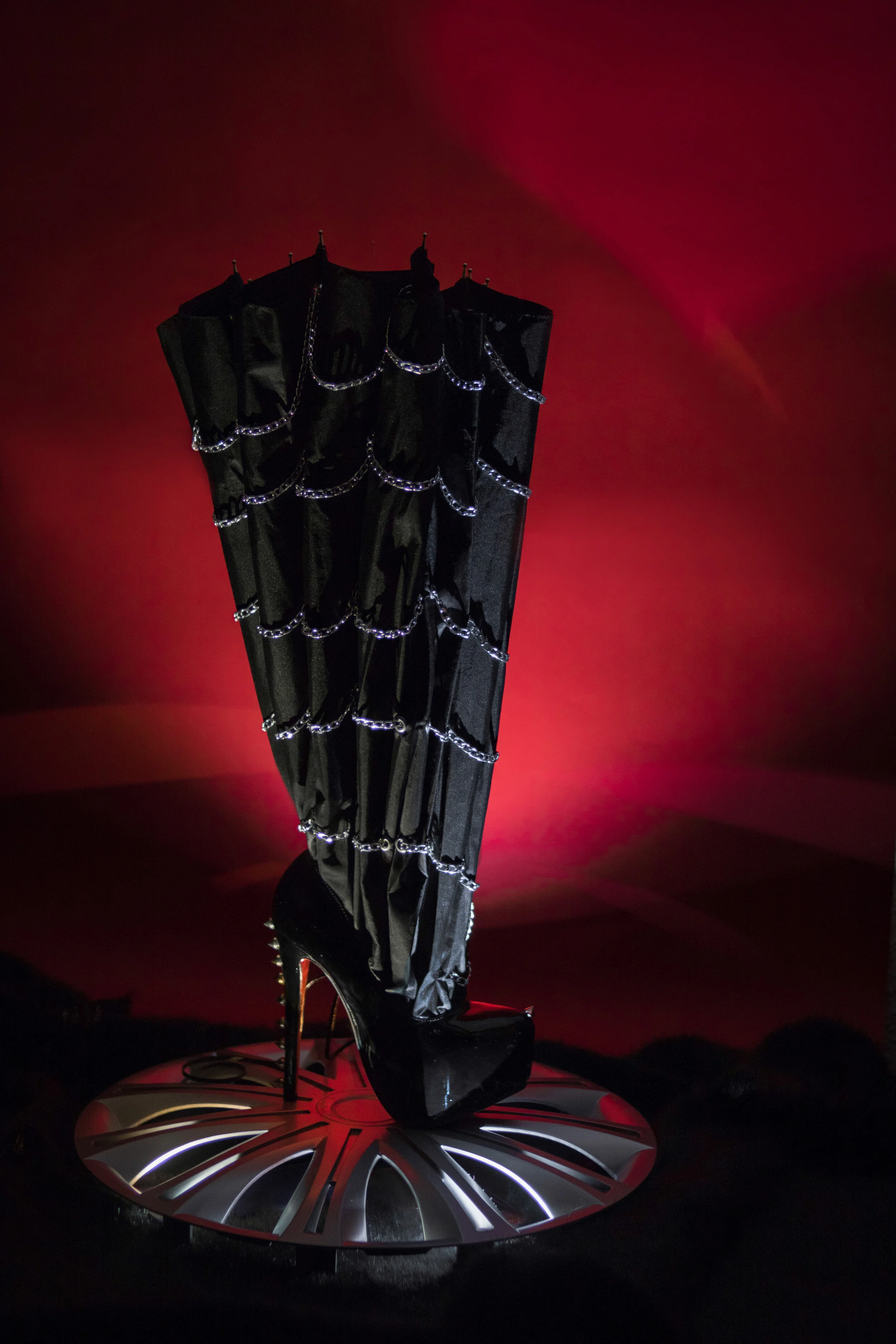 Photo Editor/Photographer: Paola Martín Sánchez - Cuesta Stylist/Creative Director/Accessory Designer: Víctor García García Wardrobe Credits: High boot made from a shoe and an umbrella decorated with chains. Design: Víctor García