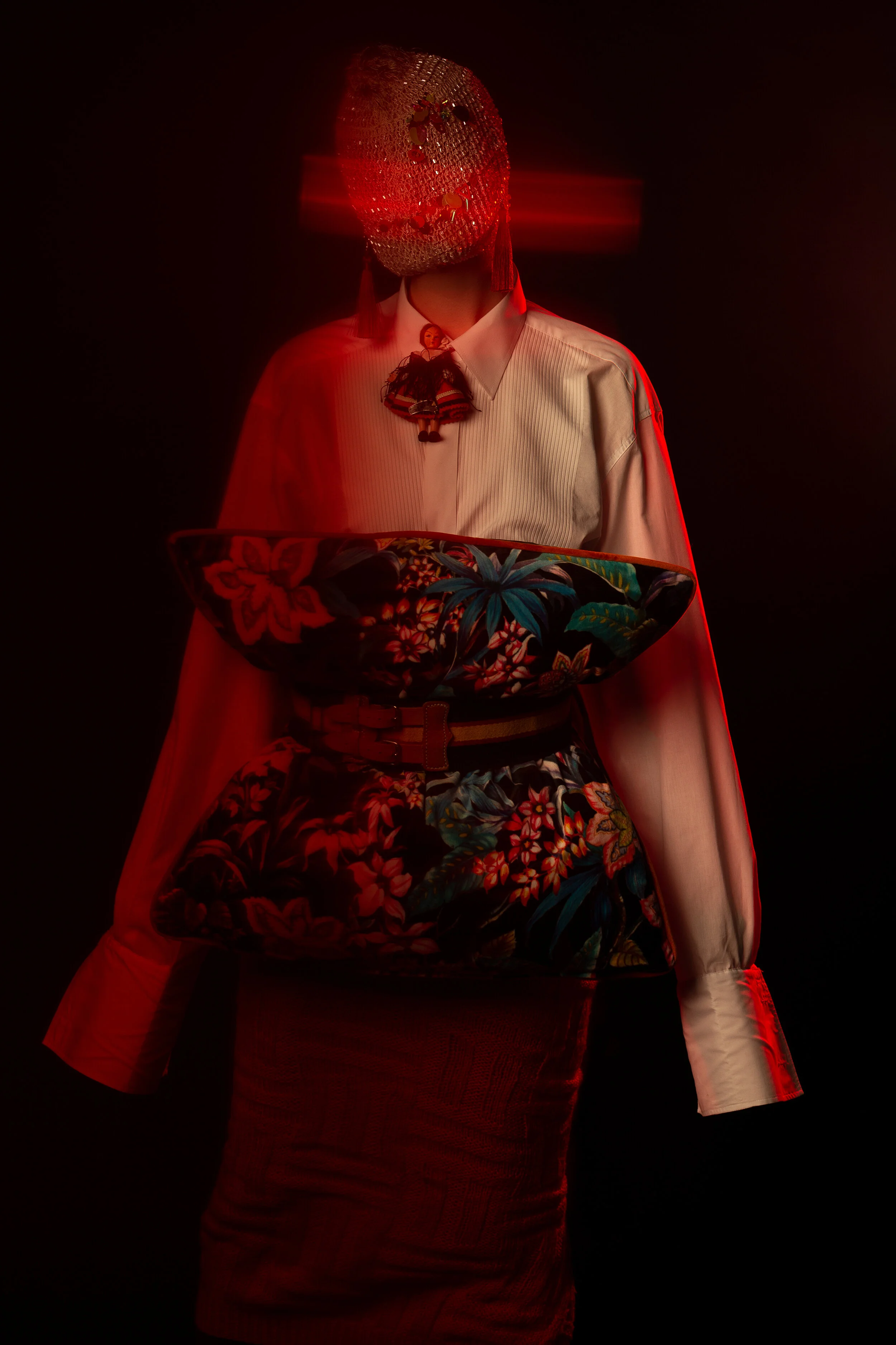 Photographer: Kevin Mora-Rosenkranz Female Model: Becca Murphs Wardrobe Stylist: Michelle Watson Wardrobe Credits: Mask: Kitsch Me Vintage Earrings: Kitsch Me Vintage Neckpiece: Vintage Spanish doll Shirt: Eton Shirts Belt: Remme Belt Cushi