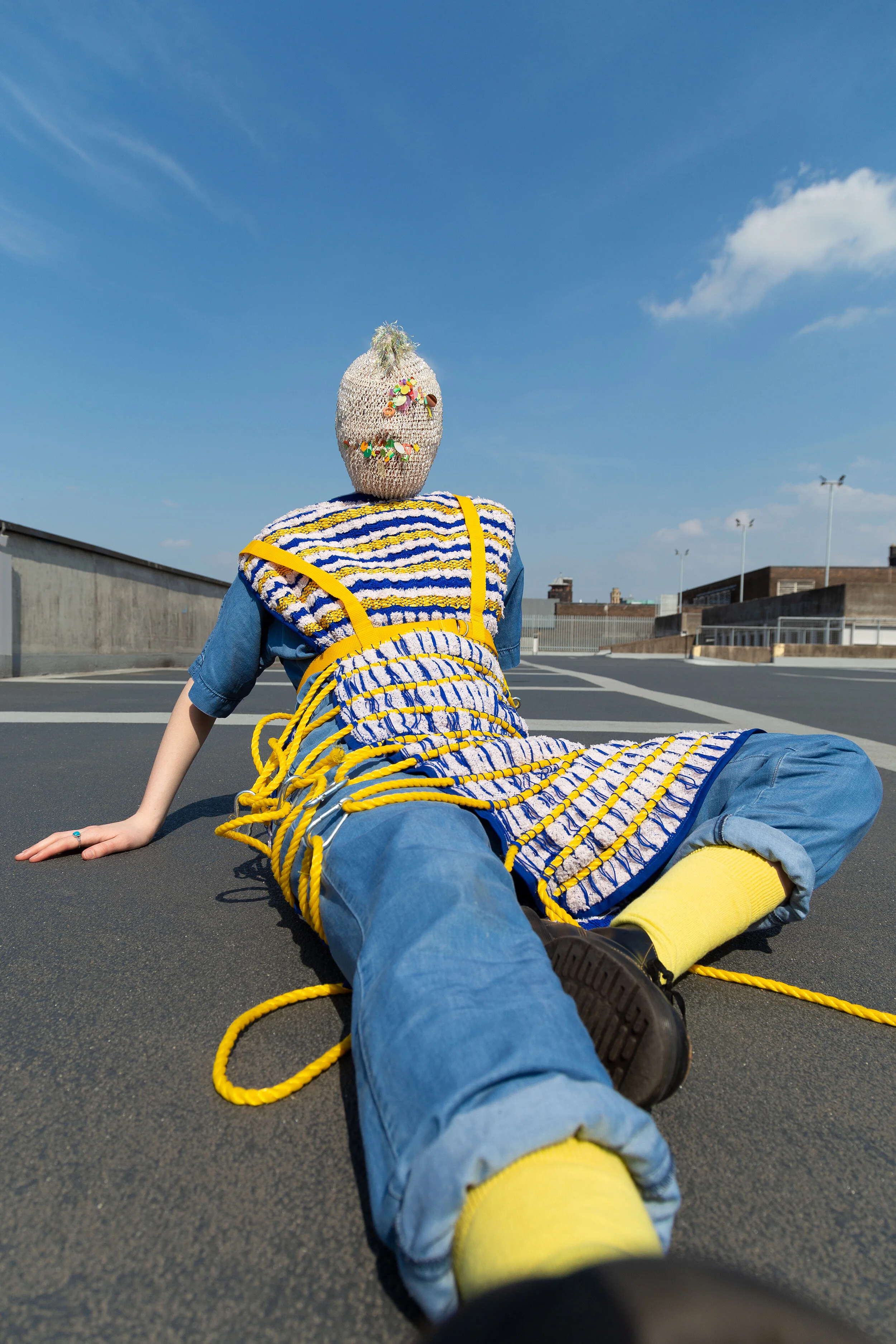 Photographer: Kevin Mora-Rosenkranz Female Model: Becca Murphs Wardrobe Stylist: Michelle Watson Textile Designer: Julie Anne Fernandez Wardrobe Credits: Mask: Kitsch Me Vintage Jacket: Julie Anne Fernandez Jumpsuit: & Other Stories Ring