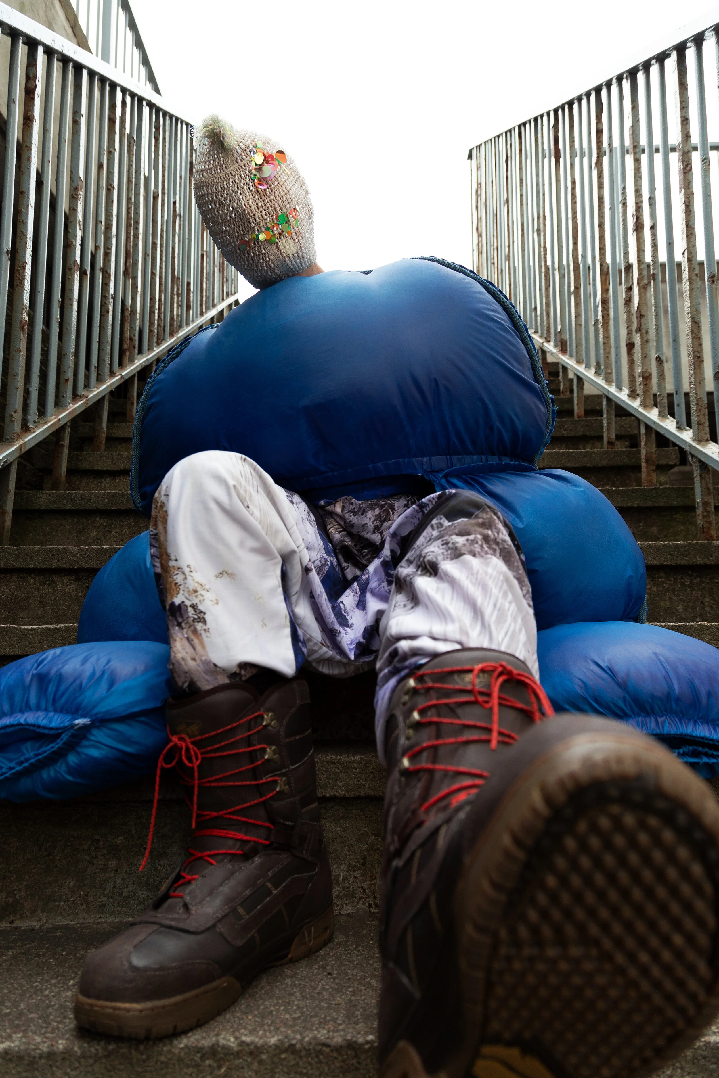 Photographer: Kevin Mora-Rosenkranz Male Model: Iain Arnott Wardrobe Stylist: Michelle Watson Fashion Designer: Isabell Ferger Wardrobe Credits: Mask: Kitsch Me Vintage Jacket: Isabell Ferger Trousers: Isabell Ferger Boots: Vans