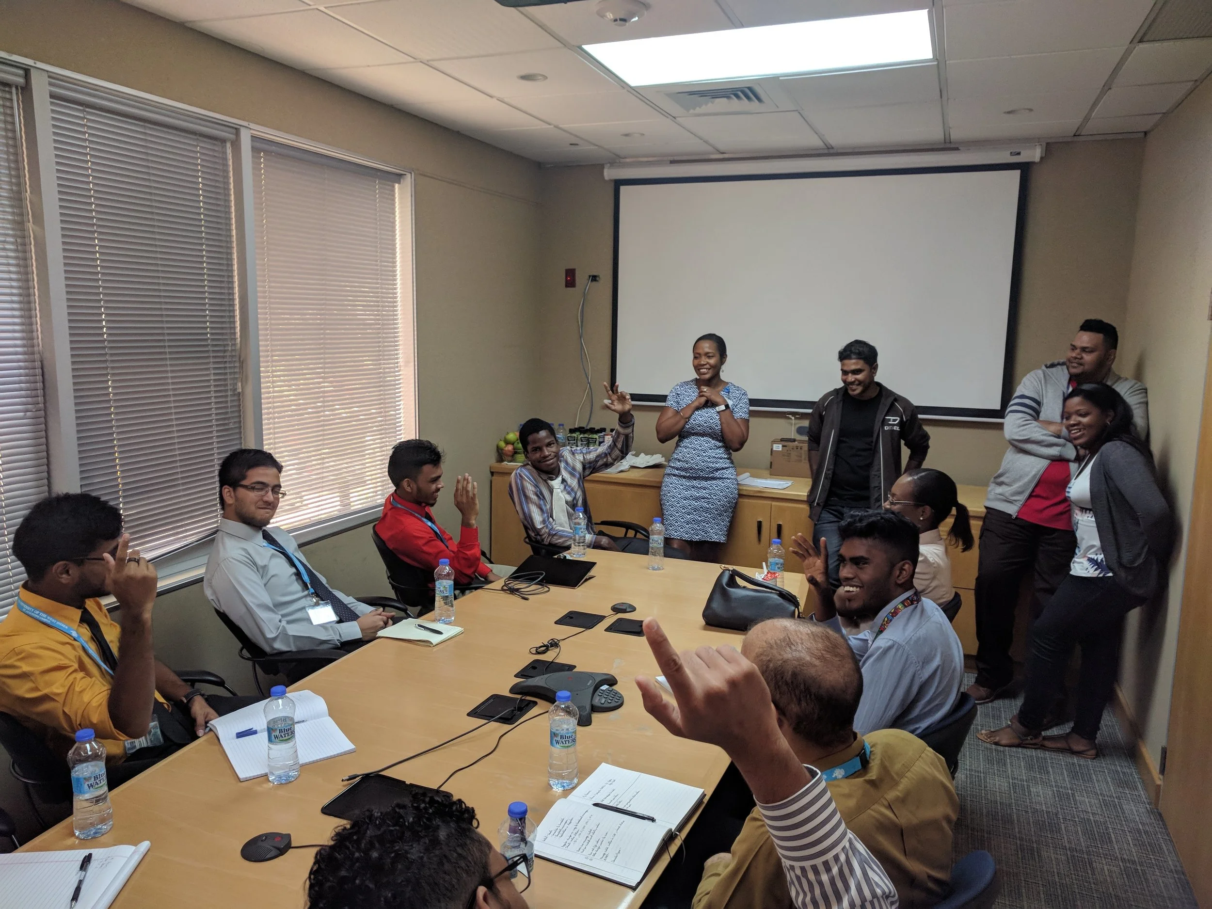 Keisha Mark-Peters, Akash Harriram, Peter Teelucksingh and Keisha Waithe of Teleios Systems Ltd. speaking to students 