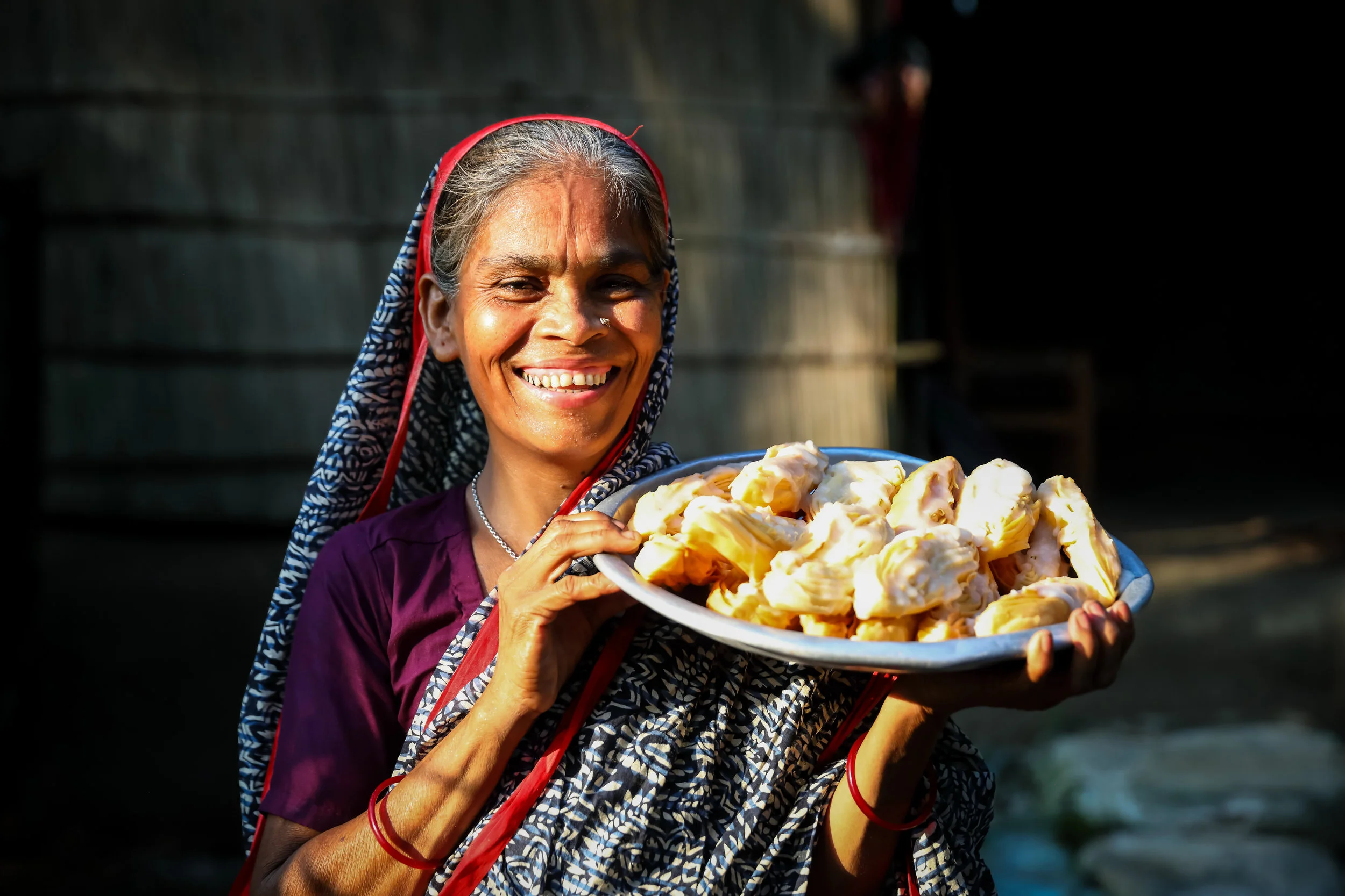 Shufia Begum took part in our project with women jute workers in Bangladesh. She stands with home-made snacks to sell in her shop. Credit: Traidcraft Exchange/GMB Akash