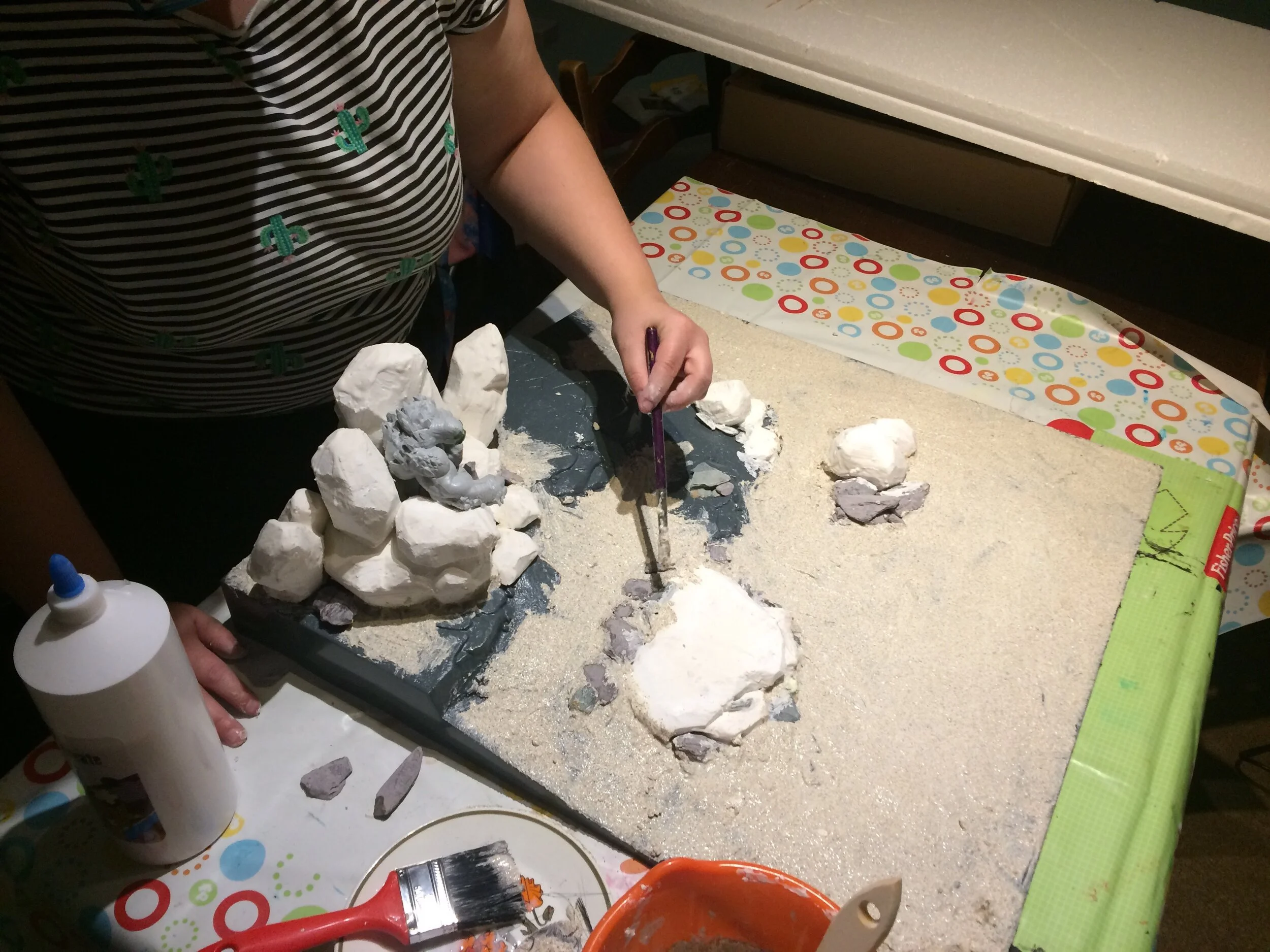 Here you can see sand mash being liberally applied onto our board.We used a mixture of big brushes, smaller brushes and a rubber spatula.