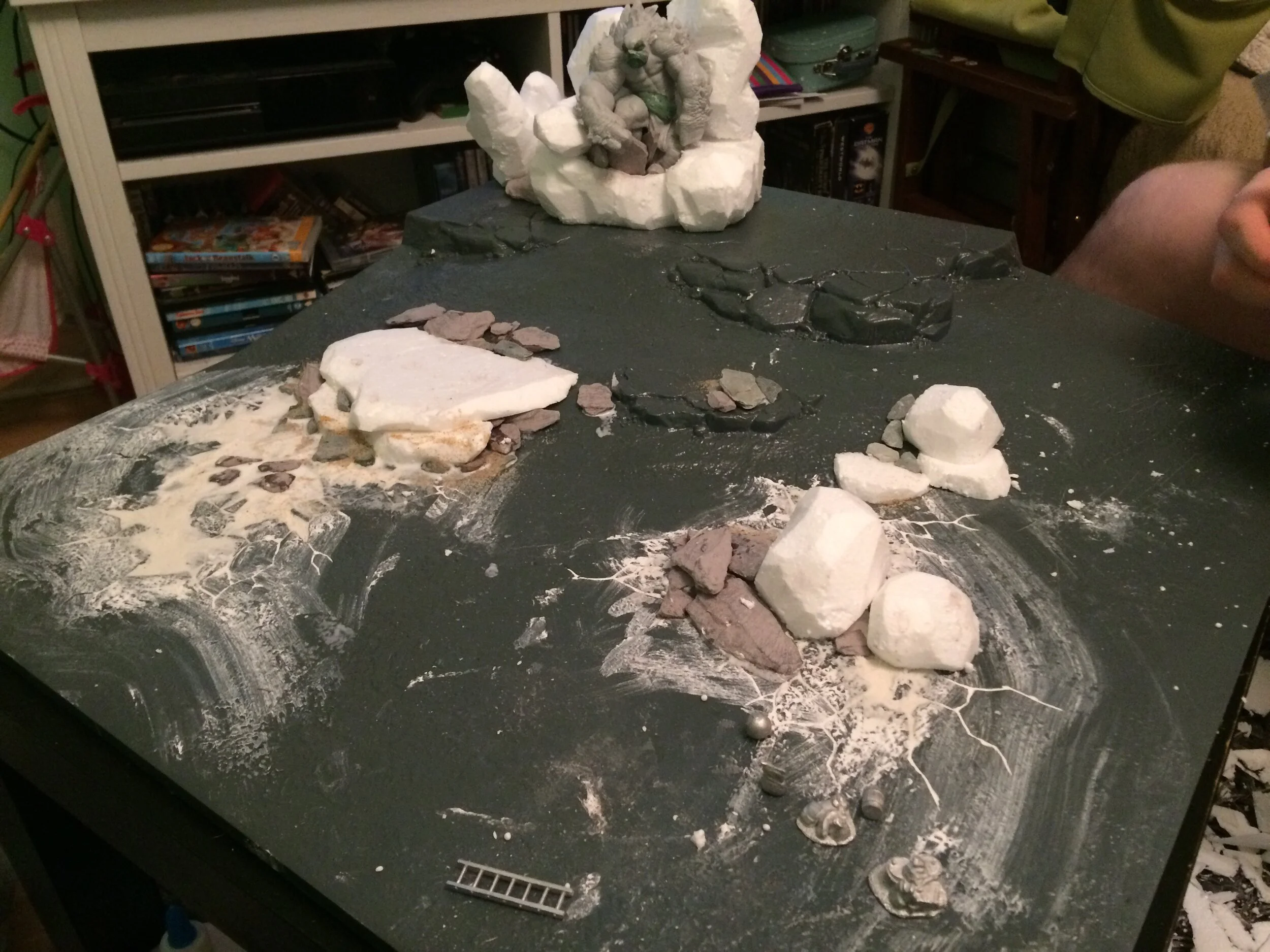 Here’s the board in progress! We added some additional rocks and flat surface area with polystyrene, and filled in the ubiquitous skull pools.