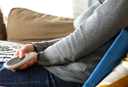 woman_with_heating_pad_on_back.jpg