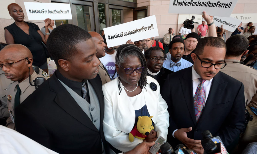 ‘We’re not about violence,’ said Jonathan Ferrell’s younger brother Willie, standing beside his mother Georgia and family attorney Chris Chestnut,right, outside the courthouse. Photograph: T Ortega Gaines/AP
