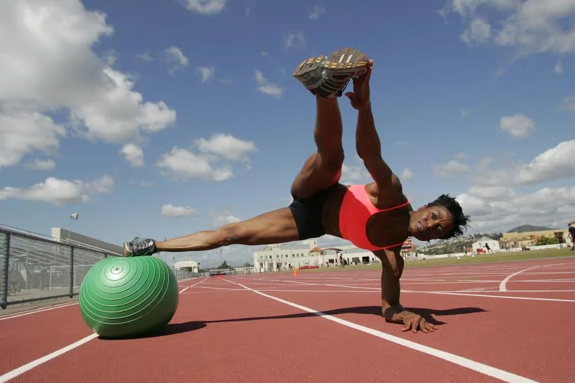 Current image: Demonstration of advanced "Flo Fusion" posture (without resistance cables or weights)