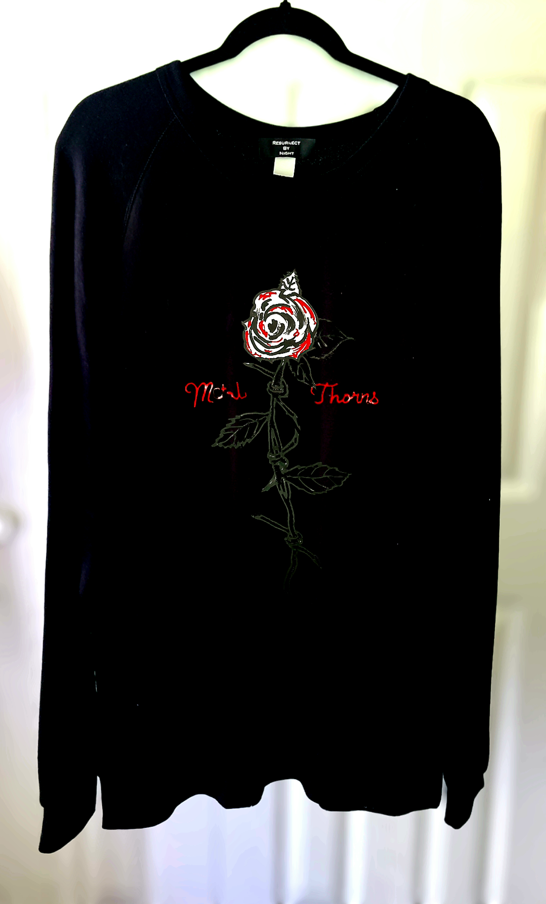 "Metal thorns" long-sleeve distressed crew.