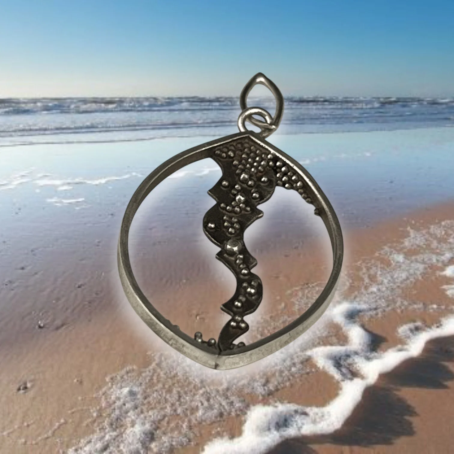 Delicate silver pendant with granules