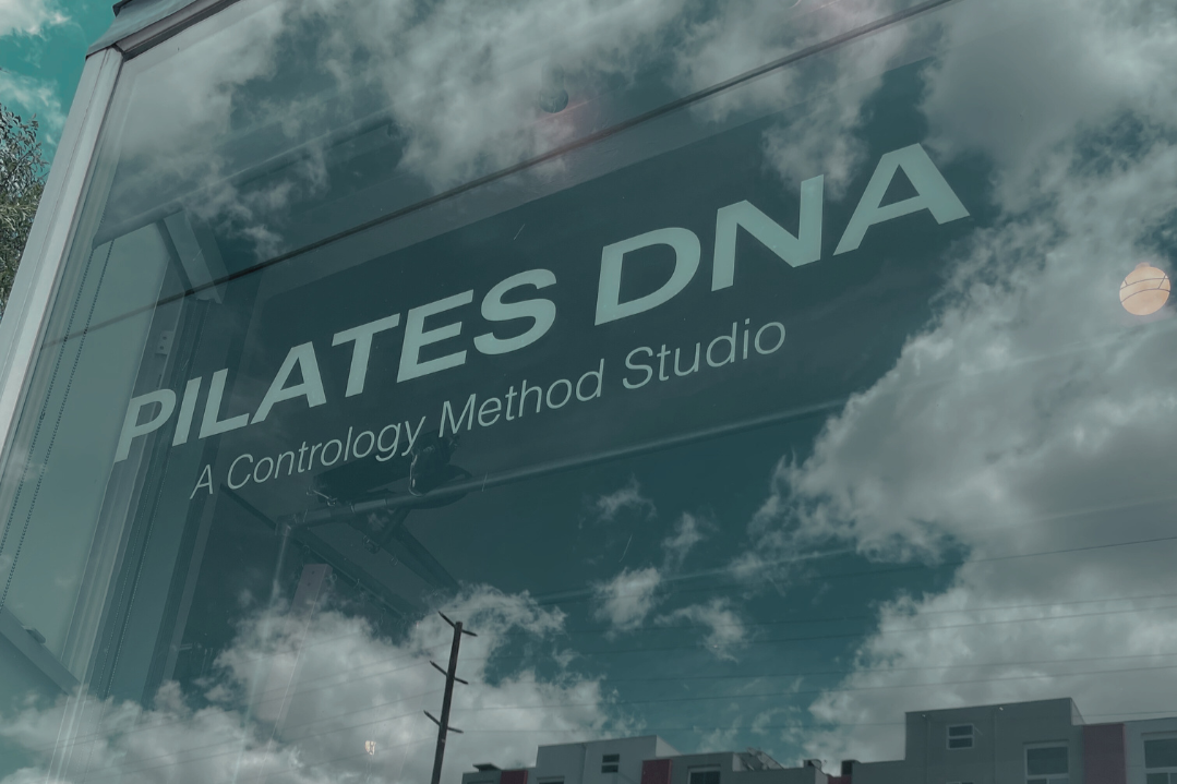 Pilates DNA sign + cloud reflection