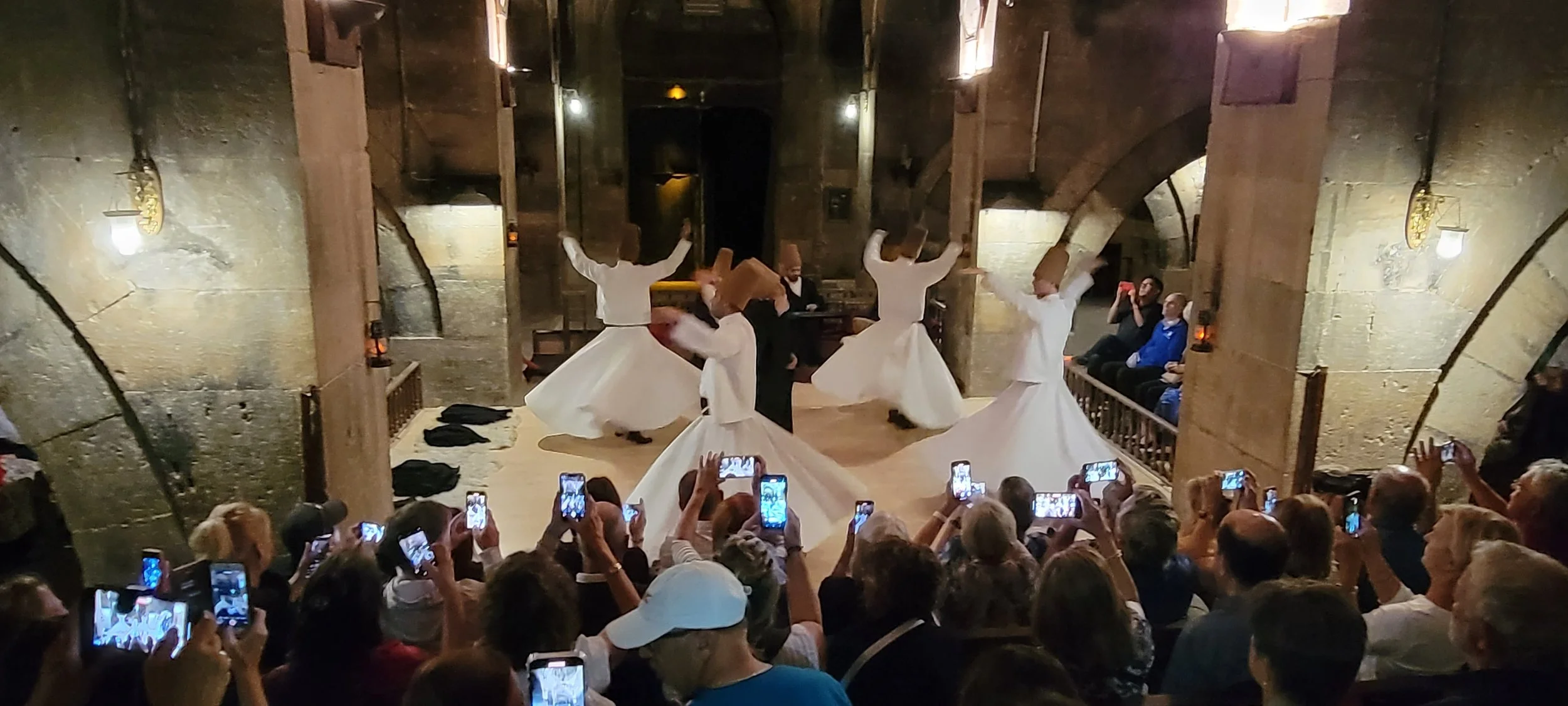 Dervishes with Tourists, Saruhan Caravanserai, Turkey