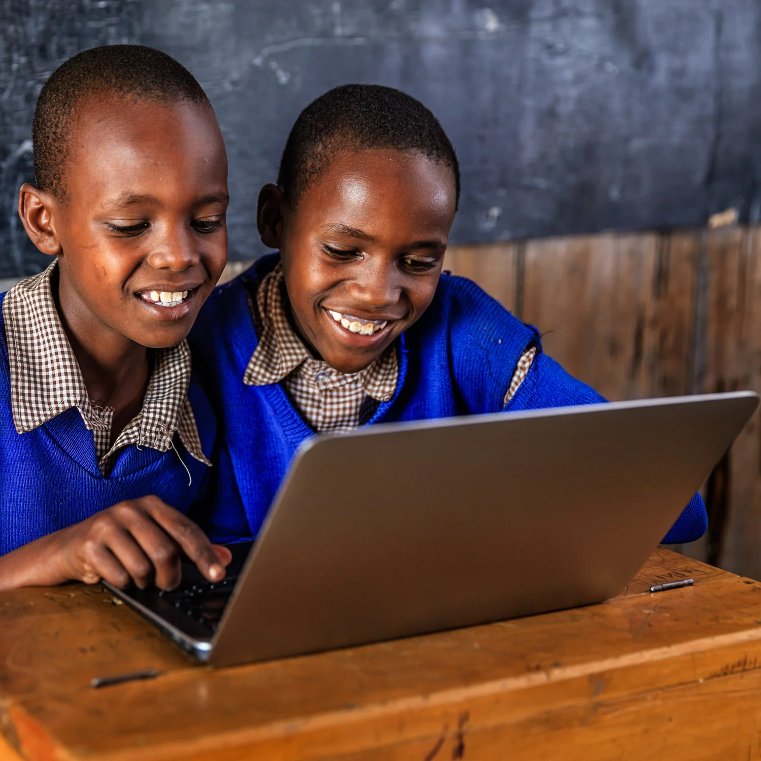 African children using a laptop inside school classroom in remote area of southern Kenya. Image credit: Bartosz Hadyniak/Getty Images