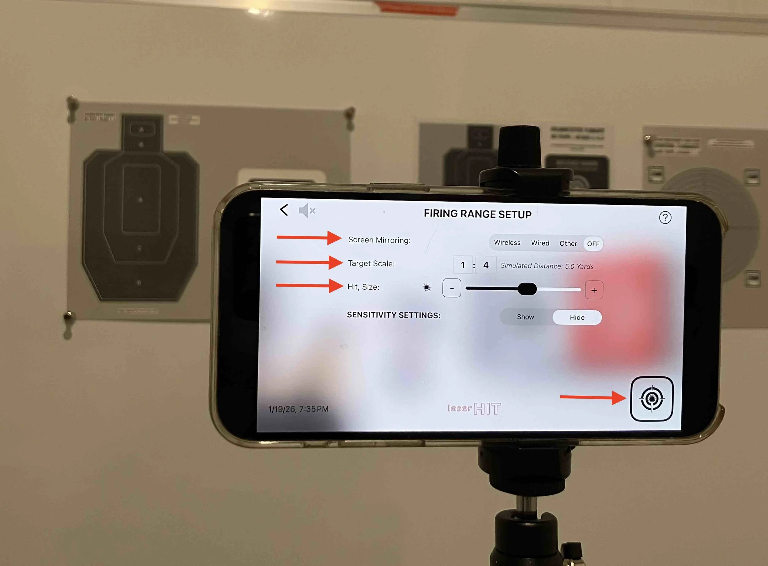 LaserHIT app firing range setup screen showing target scale, hit size, and simulated distance with B3 targets mounted on an indoor wall