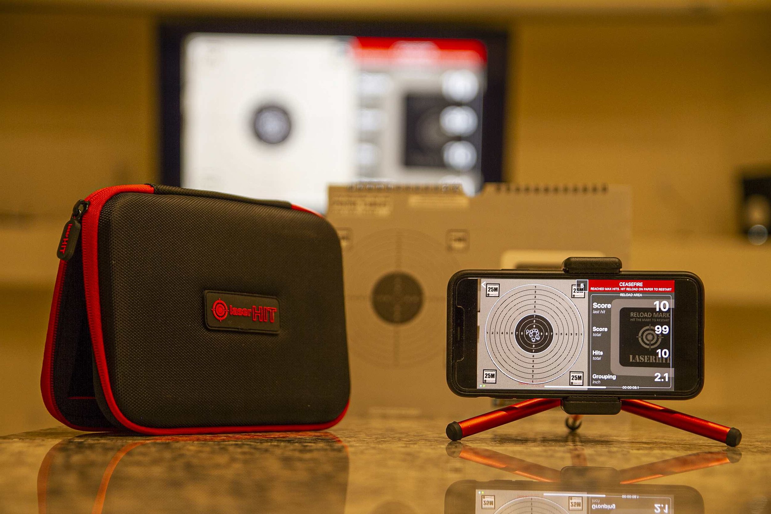 LaserHIT dry-fire kit with mobile app showing real-time shot placement on physical target