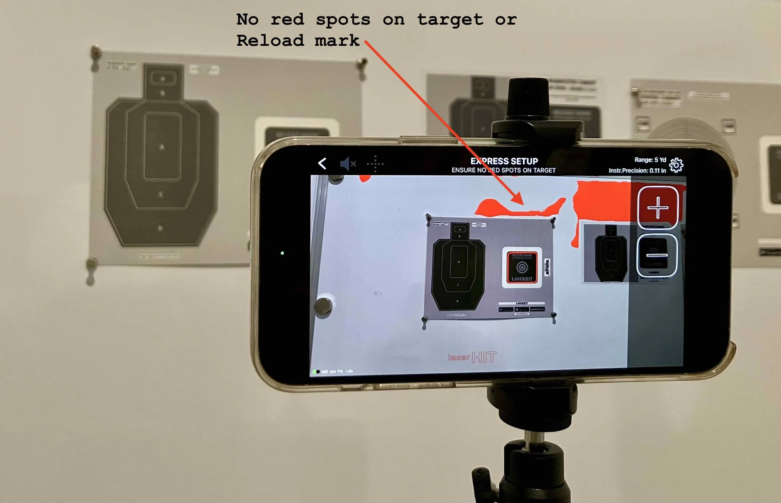 LaserHIT Express Setup screen showing detection warning with red spots on wall near target and reload mark during indoor accuracy drill setup