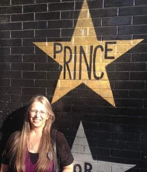 Kathy Holzer poses in front of Prince's First Avenue star.
