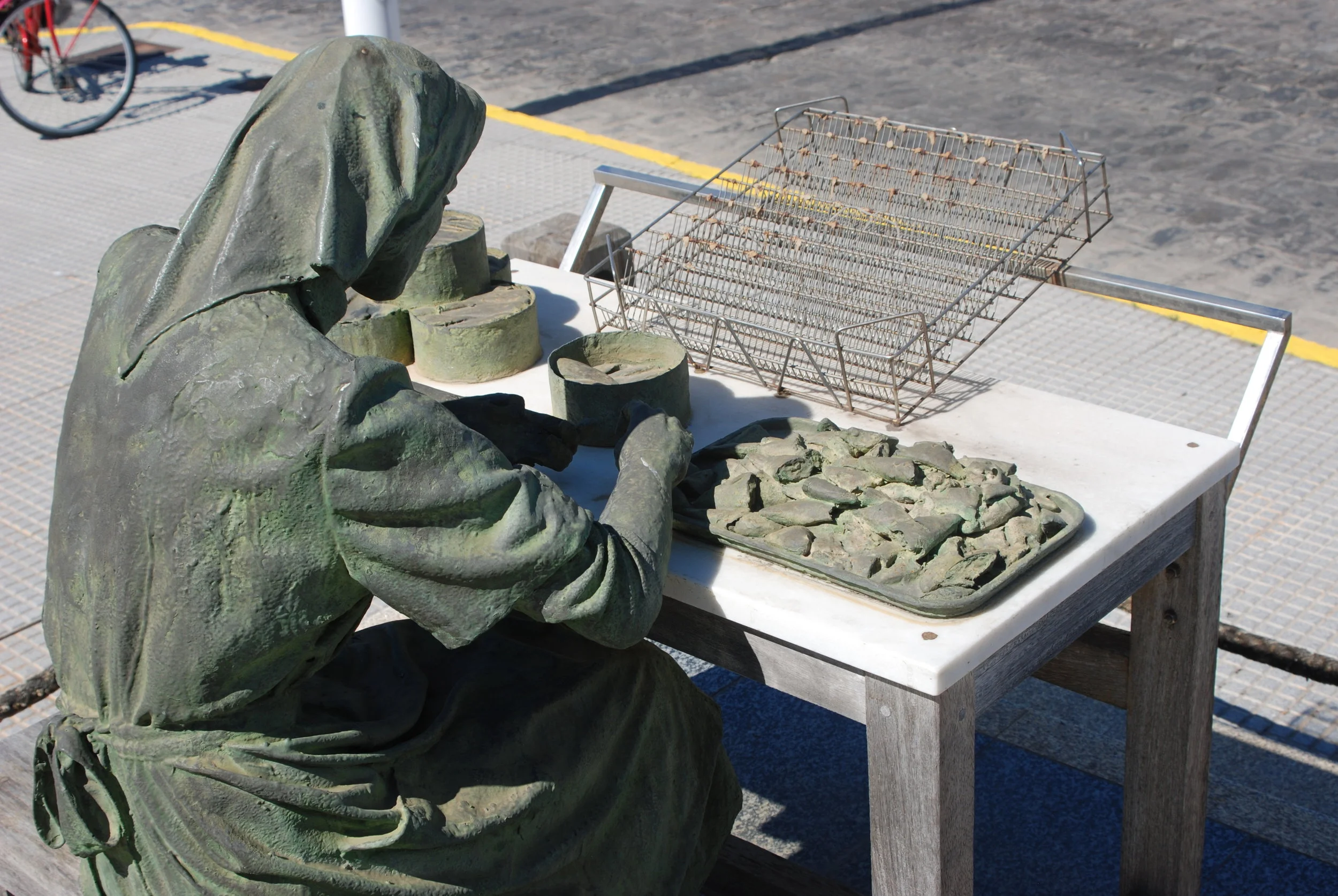 This monument of The Fish Preserving Lady, shows a a woman filleting fish in the Southern Spanish tradition still practiced today.