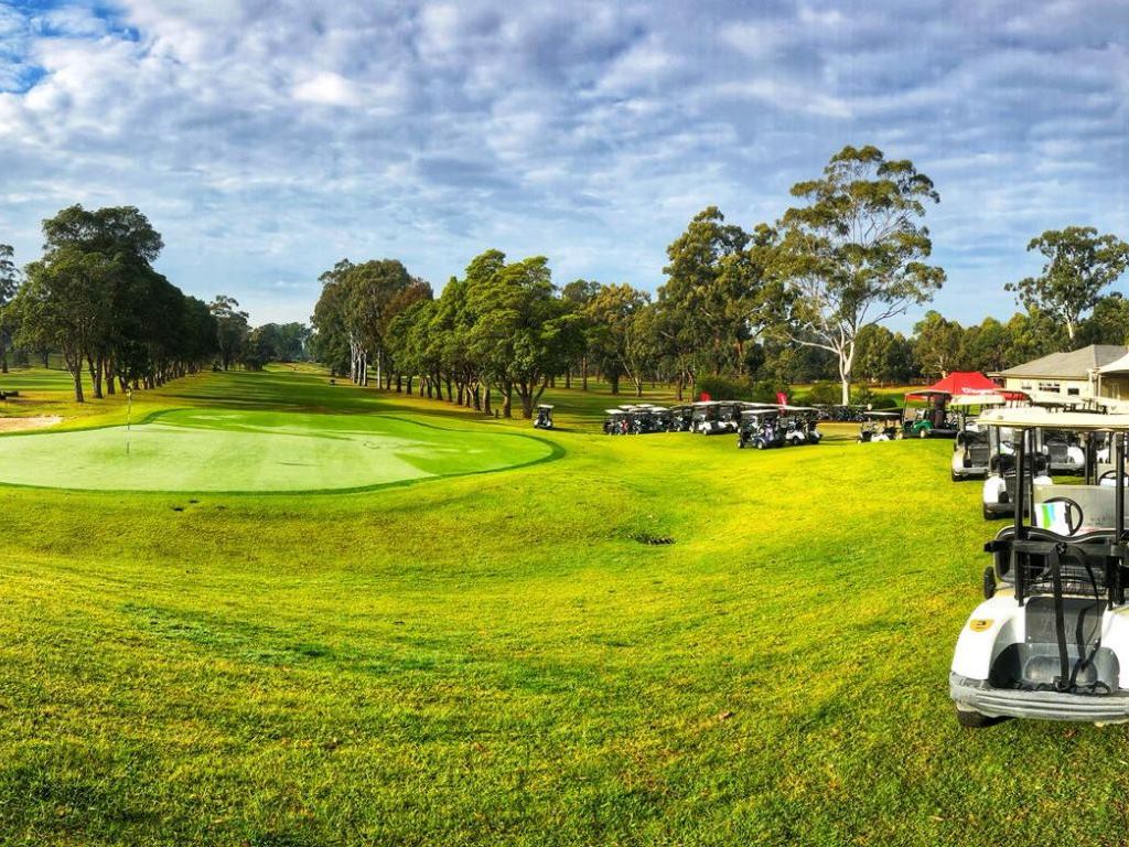 Brighter weather than last year breaks over a pristine morning green.
