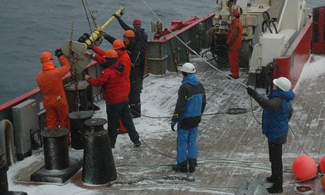 Helen Czerski, in the blue coat, helps lower the bubble buoy over the stern of the British Antarctic Survey ship, the James Clark Ross. Photograph: Helen Czerski