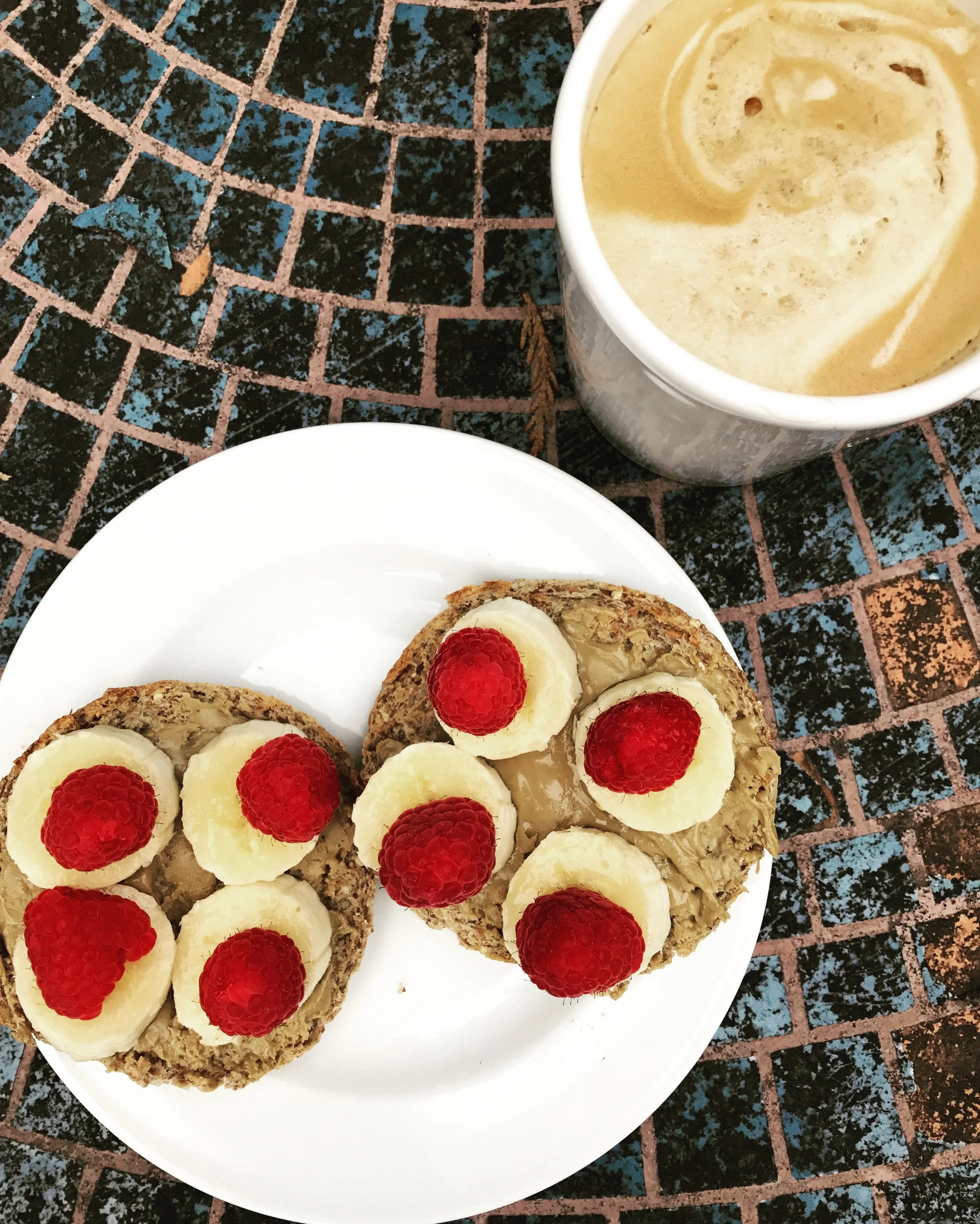 Ezekiel English Muffin with SunButter, Banana, and Raspberries! &nbsp;