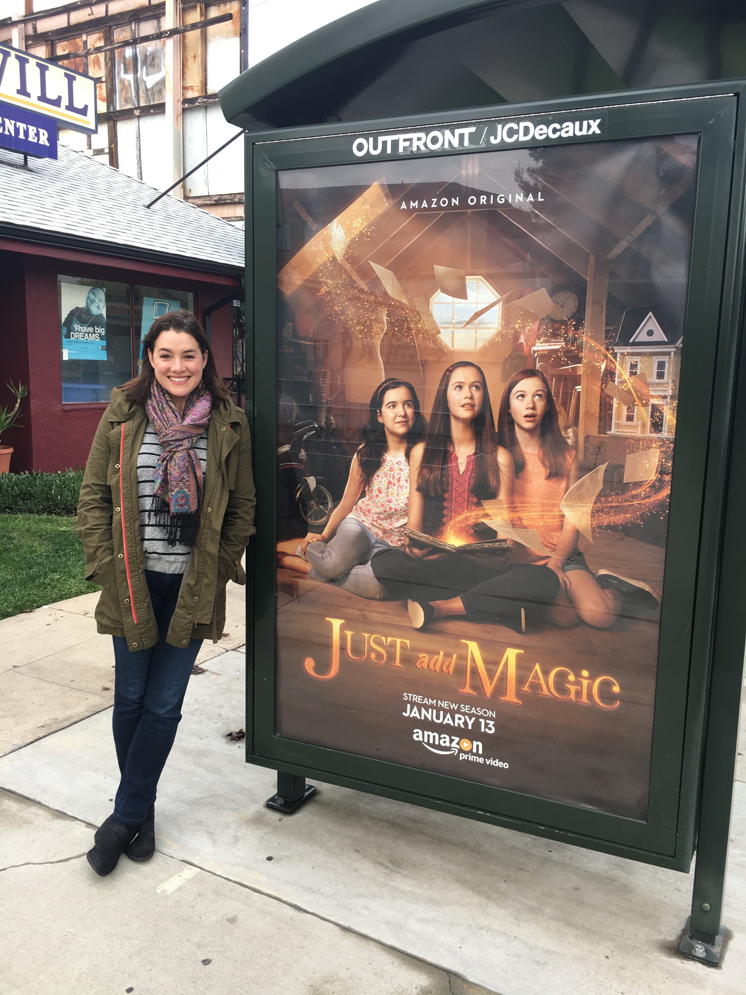 Catia Ojeda next to an advertisement for "Just Add Magic."