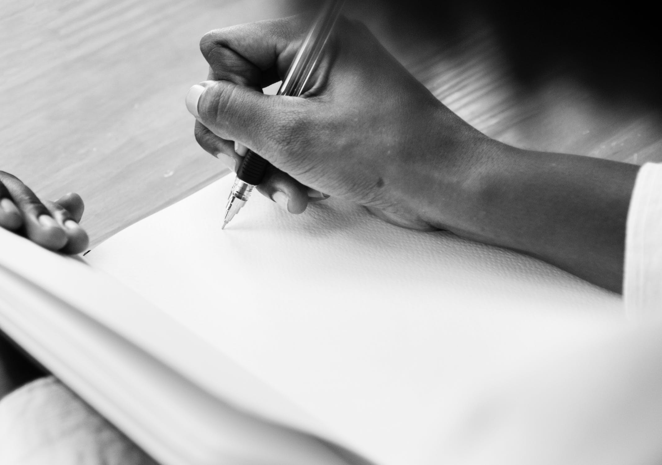 Woman writes in blank notebook