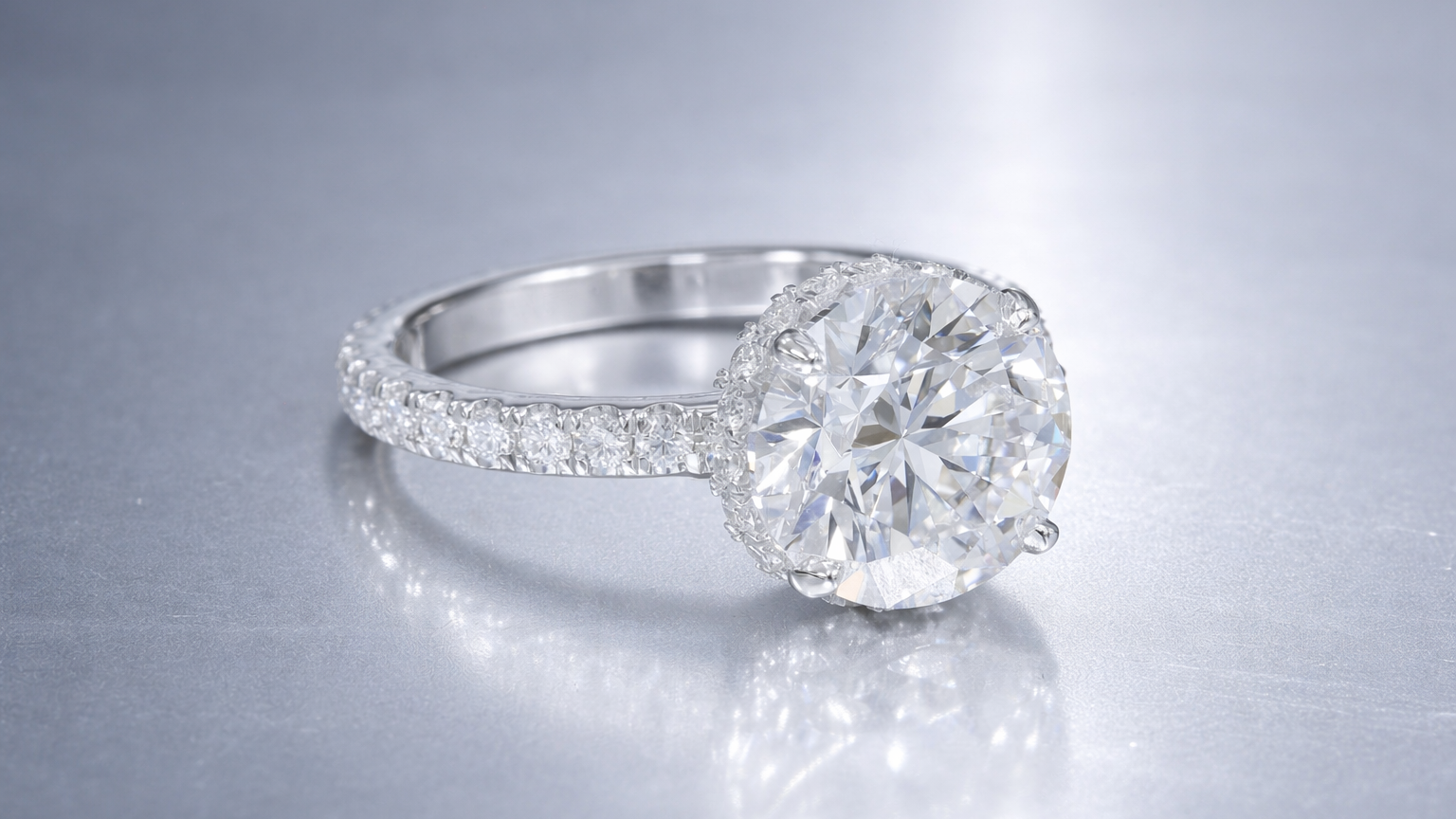 Round brilliant diamond engagement ring with hidden halo and pave band white gold in Scottsdale.png