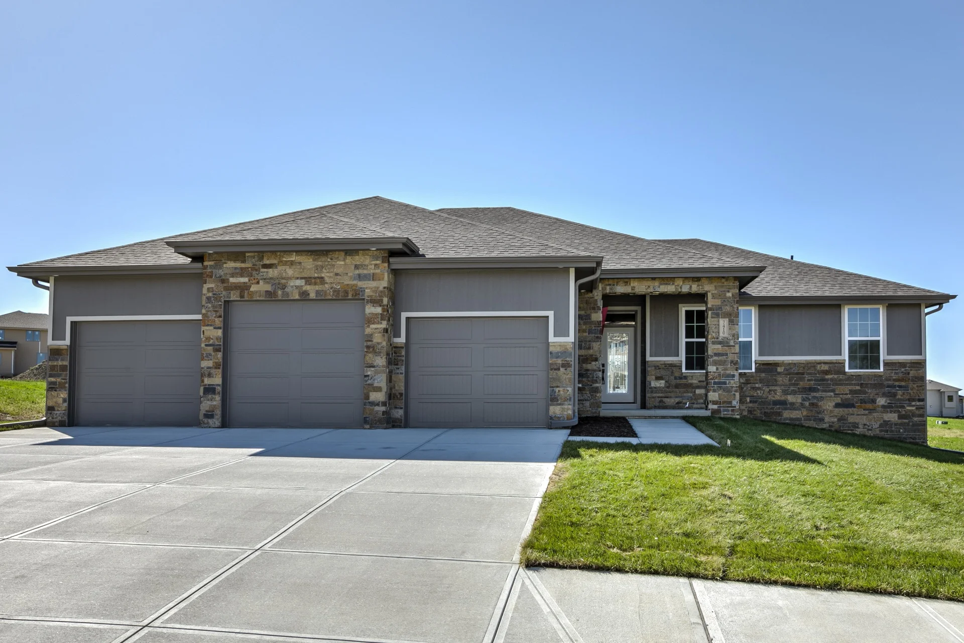 Sold home 169 Ave Bennington, Nebraska Natural stone, vaulted ceiling with alder wood beams, ship lap siding above the fireplace, custom cabinets in alder wood. Choice of flooring...we use true 3/4" wood flooring. Barn door into the master bath, wonderful wide trim accents.