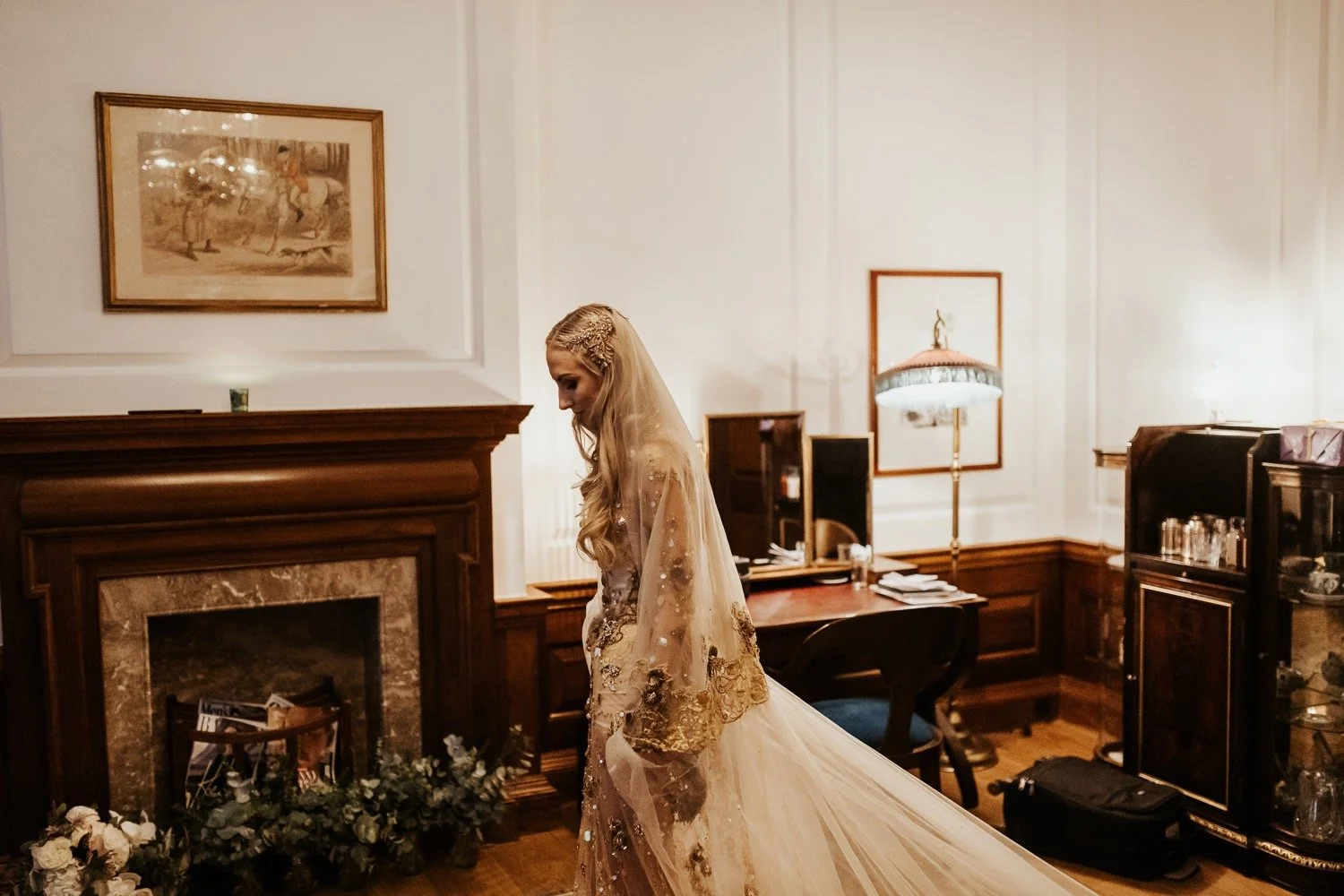 A bride wears a gold wedding dress and veil.