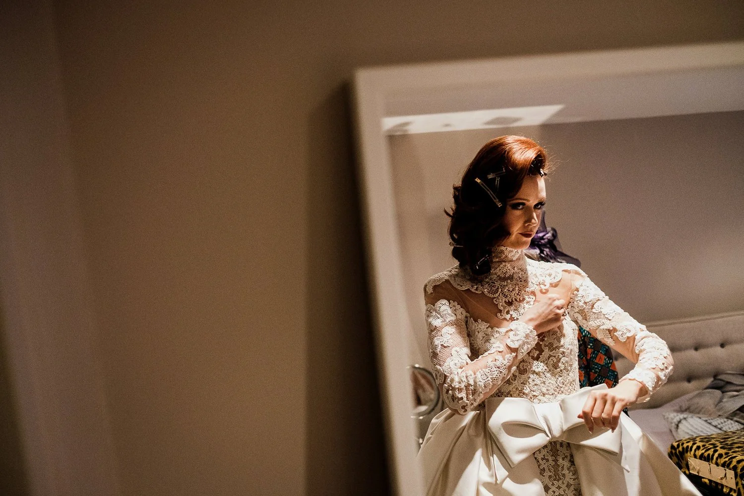 heavy guipure lace are embroidered onto illusion tulle to give the impression that the bride is wearing an off shoulder lace wedding dress with deep plunging neckline and a high collar lace necklace. 
