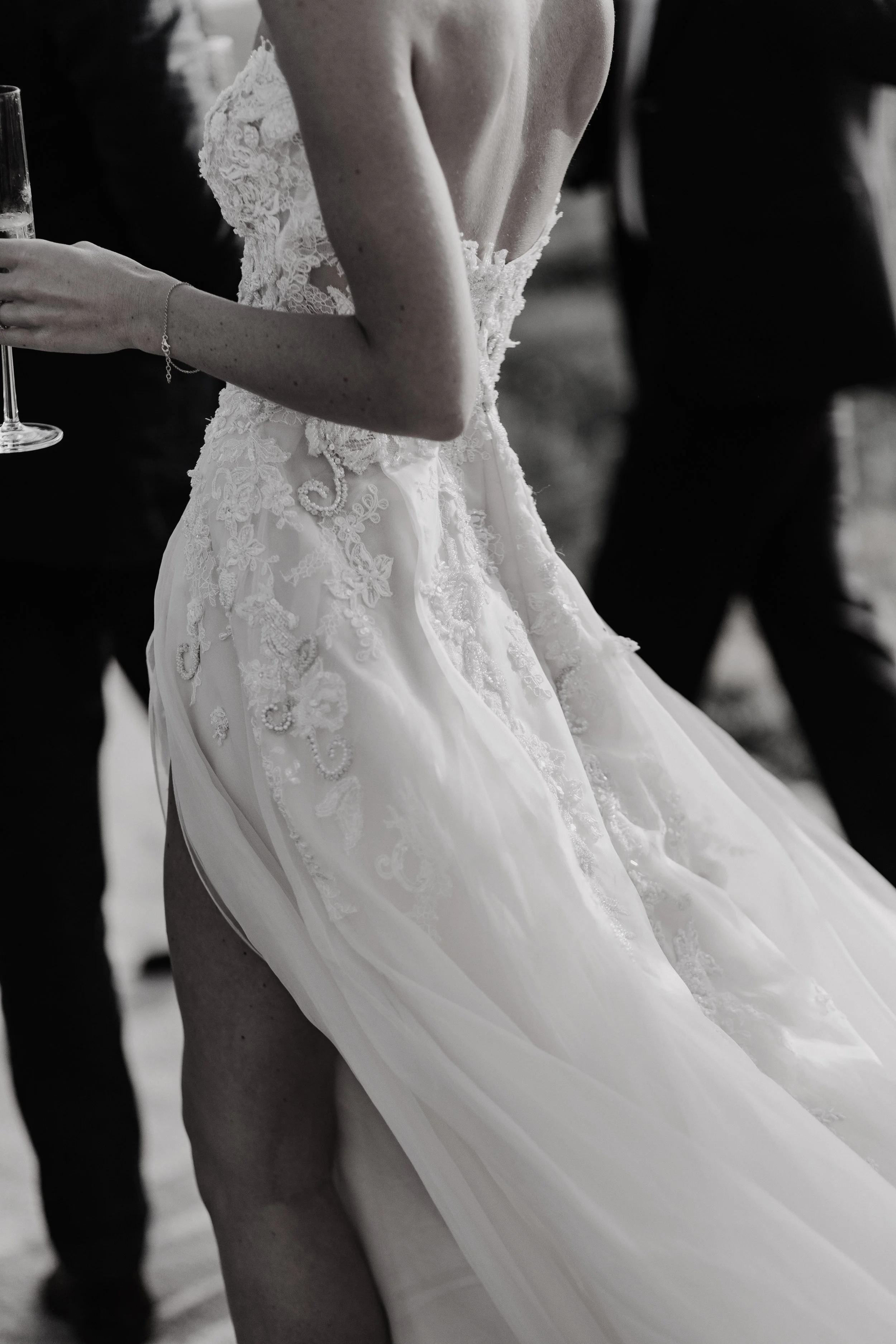  beaded lace is embroidered onto a corsetted ballgown with flowing organza skirts. 
