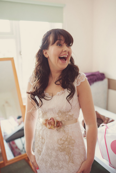  A bride wears a lace wedding dress made from the lace of her mothers wedding dress. 