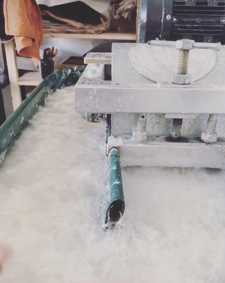  Cotton scraps being shredded and churned into paper making pulp 
