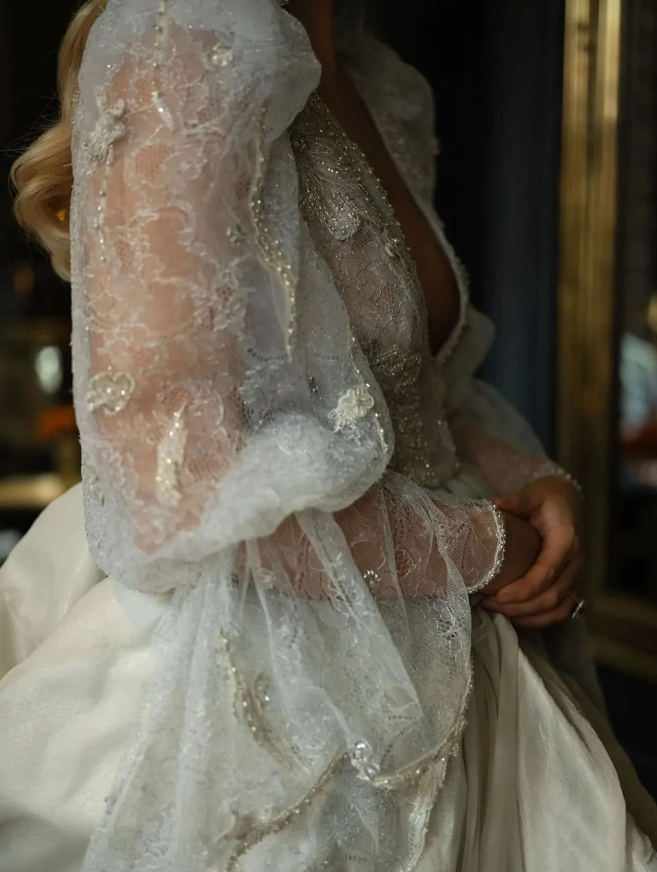 Layers of silver lace, softly sheer lace sleeves, and hand-applied beading designed to catching the light from every angle.
Considered bespoke bridal design, couture techniques, intricate embellishment, a gown created entirely for one bride.

Photogr