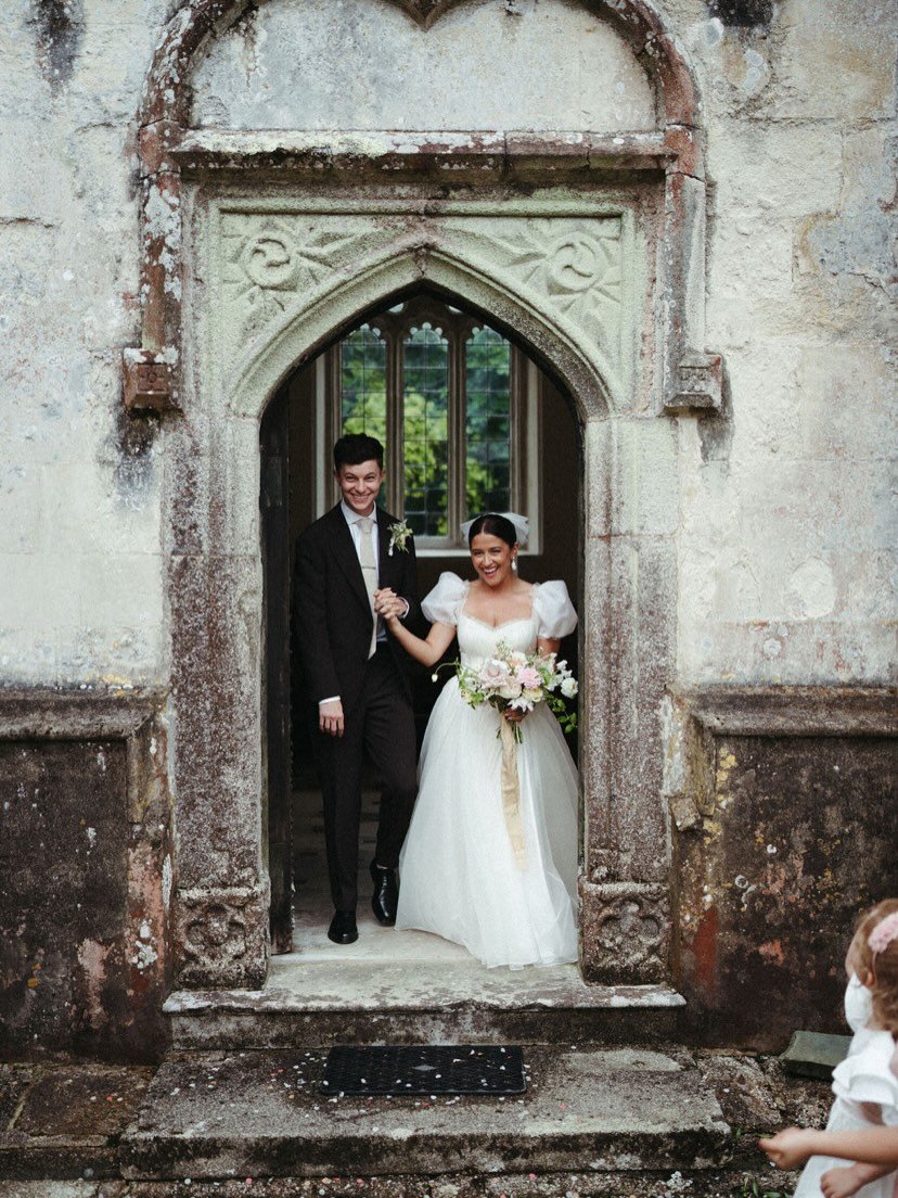 Emerging as newly weds.

Ellie, wearing a bespoke silk organza ballgown style wedding dress, with basque waist, gathered pleats on bodice, short puff sleeves and subtle sheer frill edging.

Photo by @rebeccahookphotography 

#londonbridalatelier #bes