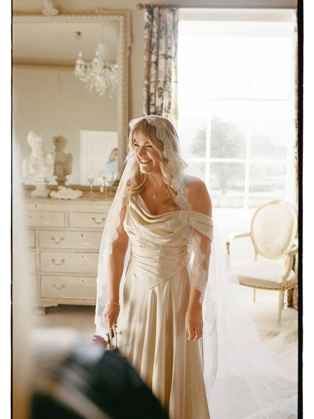 As a top wedding photographer, Emmylou envisaged the details of her own wedding from her unique photographic perspective. 

The warmth of silk in a soft golden hue, created depth in the vast winter light at Garthmyl Hall.

Cut with a draped neckline,